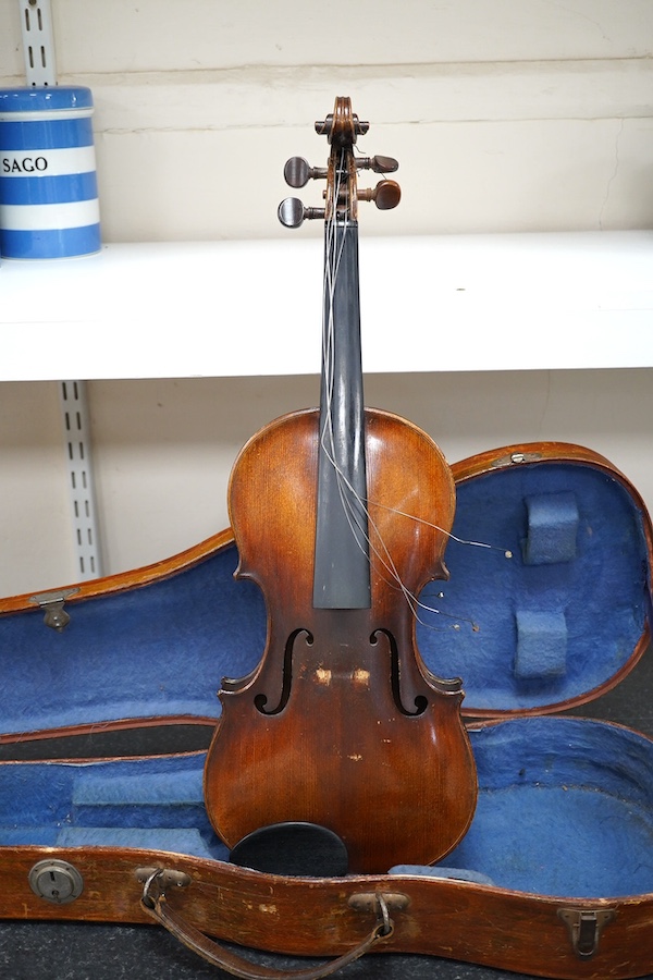 A cased violin, possibly German, body 35.5cm, in a good wooden case with canvas outer cover. Condition - fair                                                                                                               