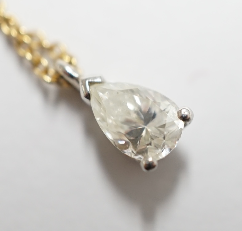 A white metal and pear shaped diamond set pendant, overall 7mm, on a fine link 18ct gold necklet, in a Tiffany & Co box. Condition - good                                                                                   