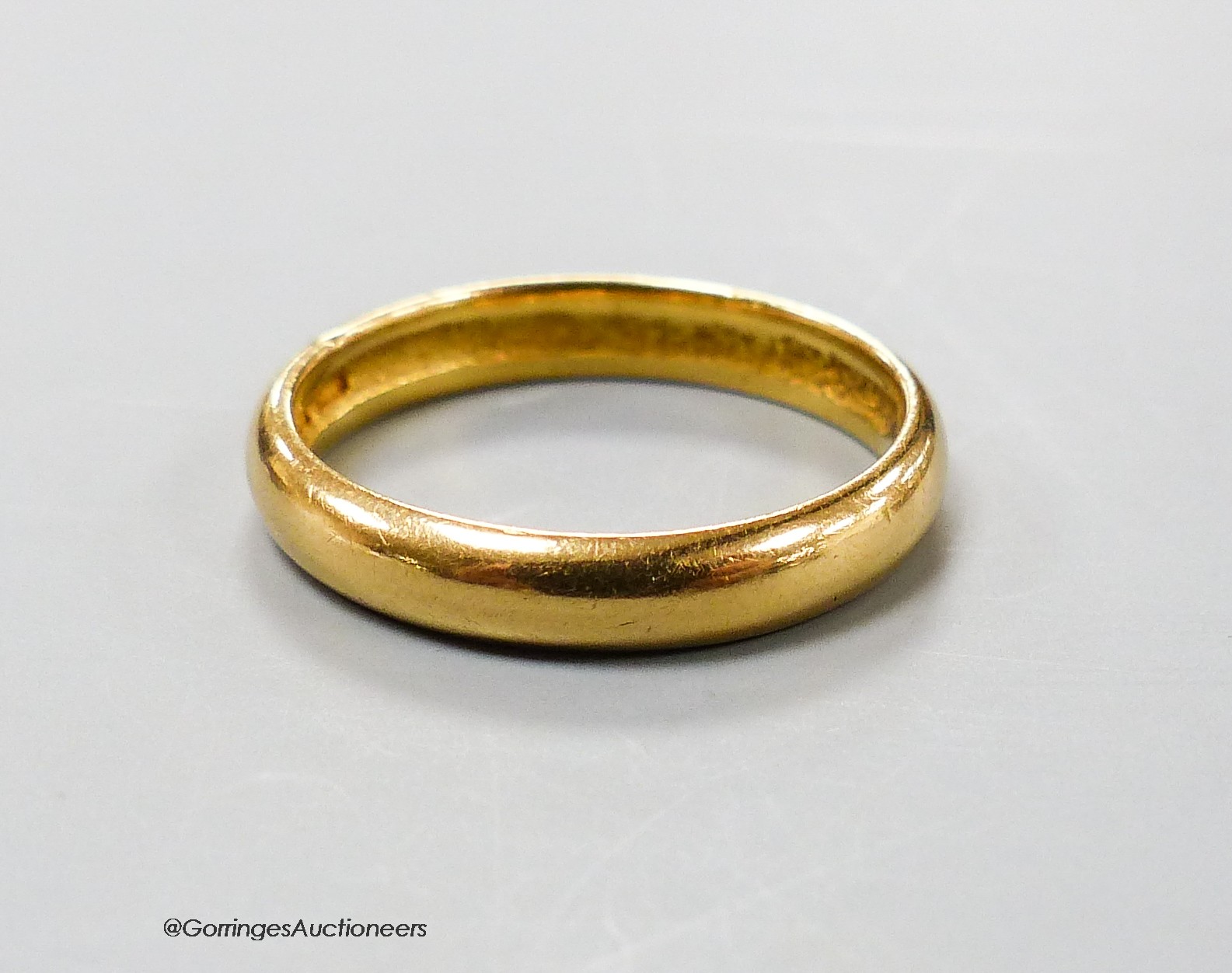 A 22ct gold wedding band, size O, 4.3 grams.                                                                                                                                                                                