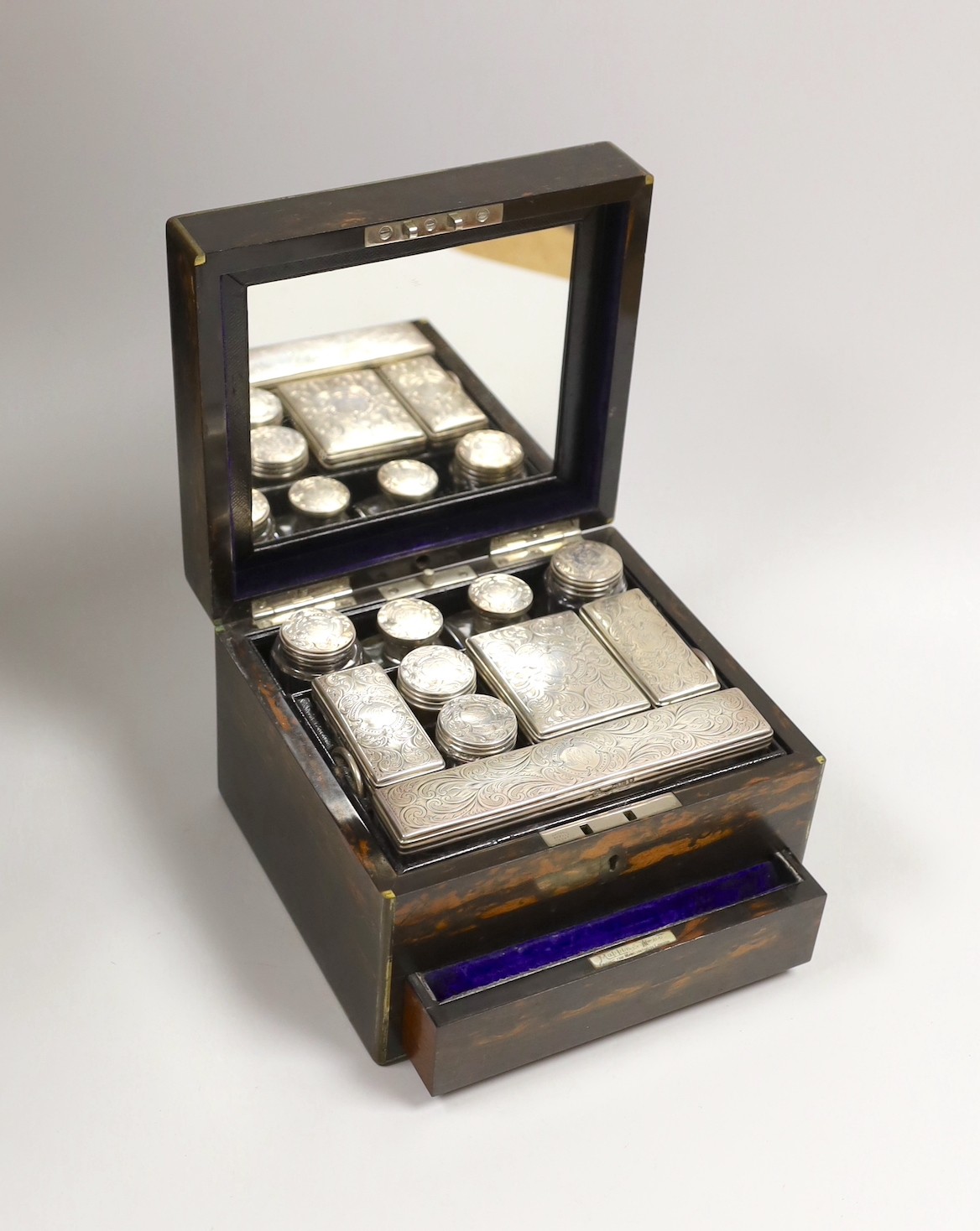 A late Victorian Mappin & Webb coromandel wood toilet box, containing ten silver mounted toilet jars, George Betjemann & Sons, London, 1895, box 21.2cm, mechanism for drawer a.f.                                          