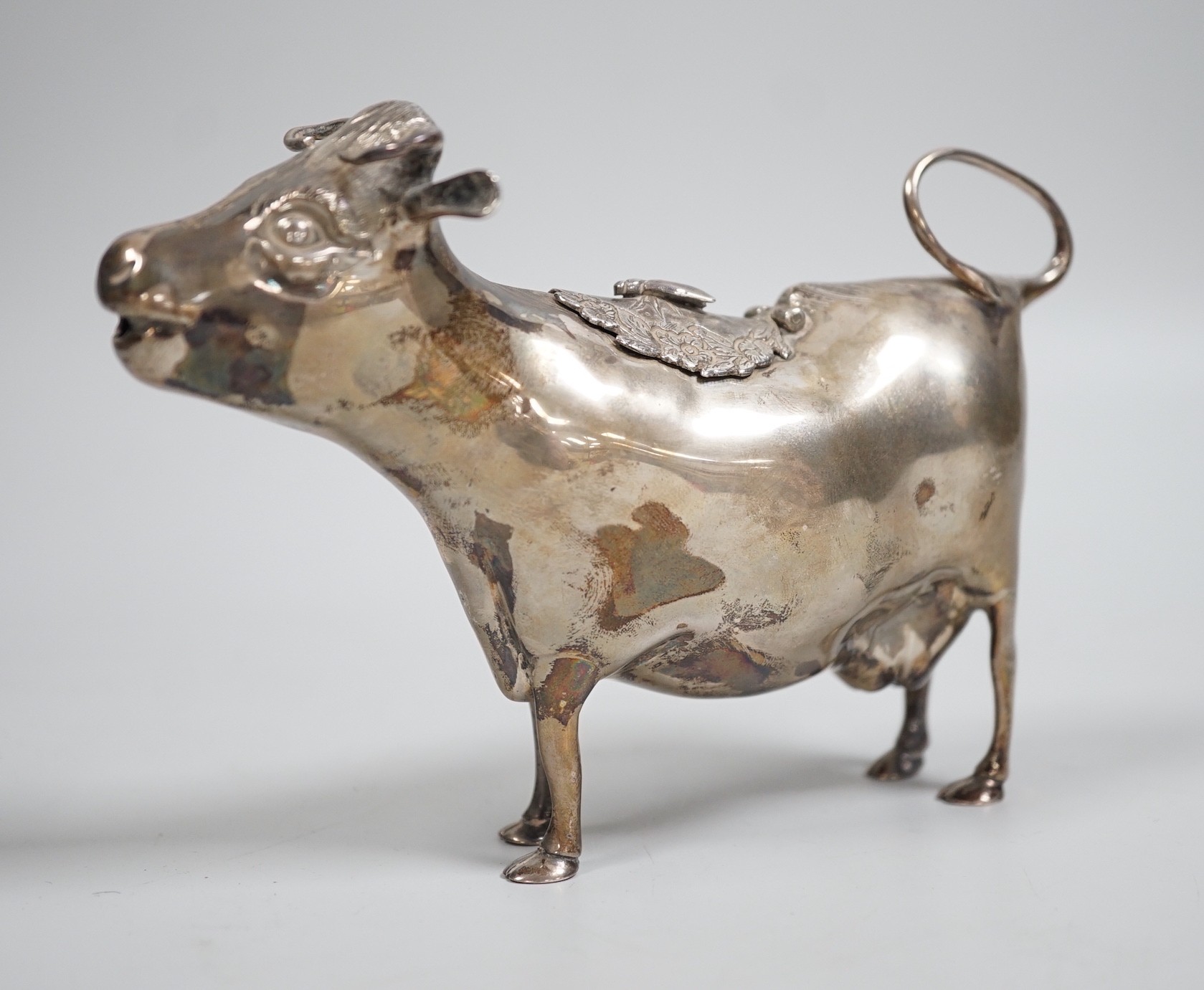 An Elizabeth II silver cow creamer, William Comyns & Sons Ltd, London, 1965, length 15cm, 152 grams.                                                                                                                        