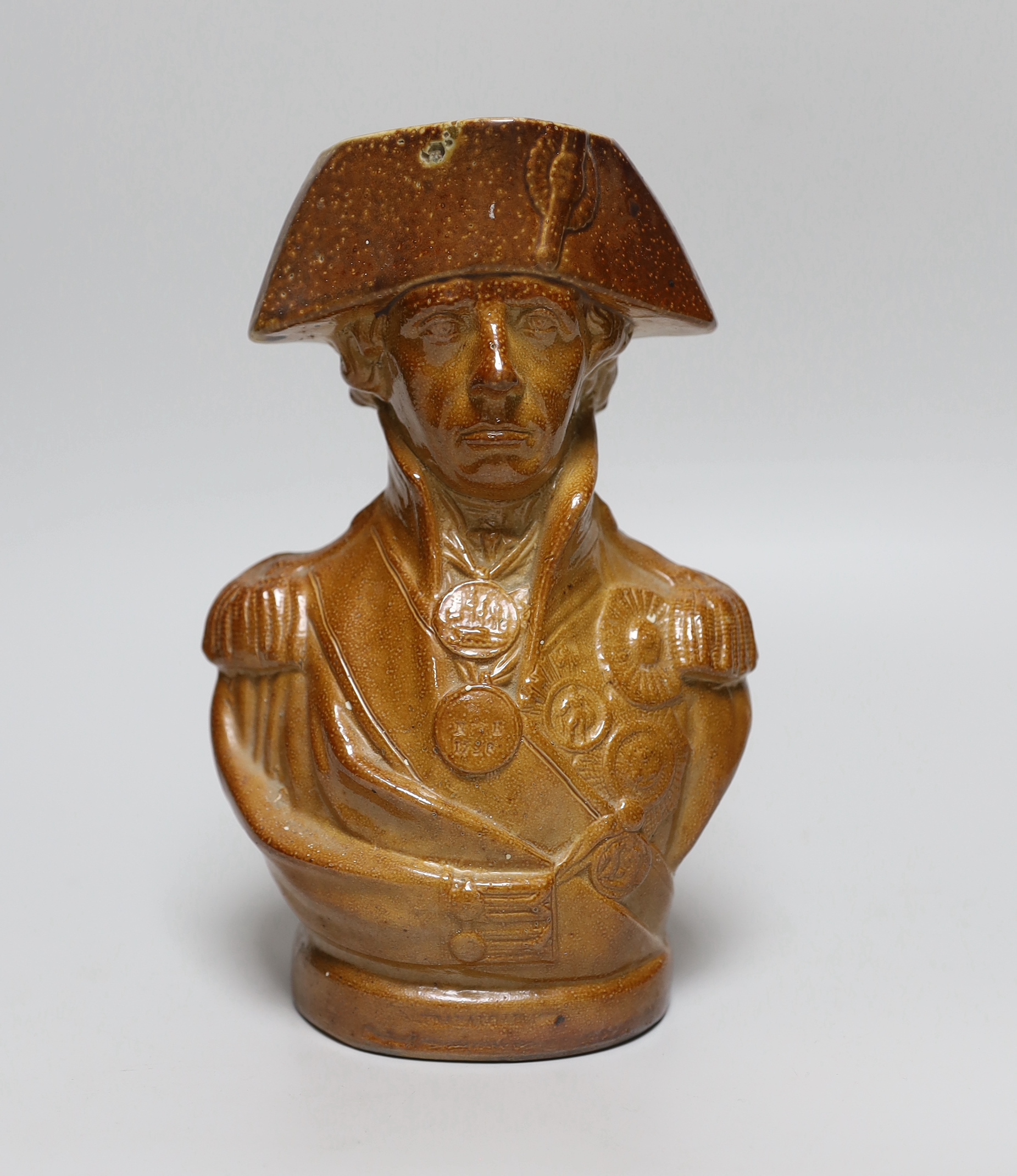 A 19th century brown salt glazed stoneware ‘Lord Nelson’ bust jug, in military dress, inscribed Nile 1798, Trafalgar 1806, 22cm high                                                                                        