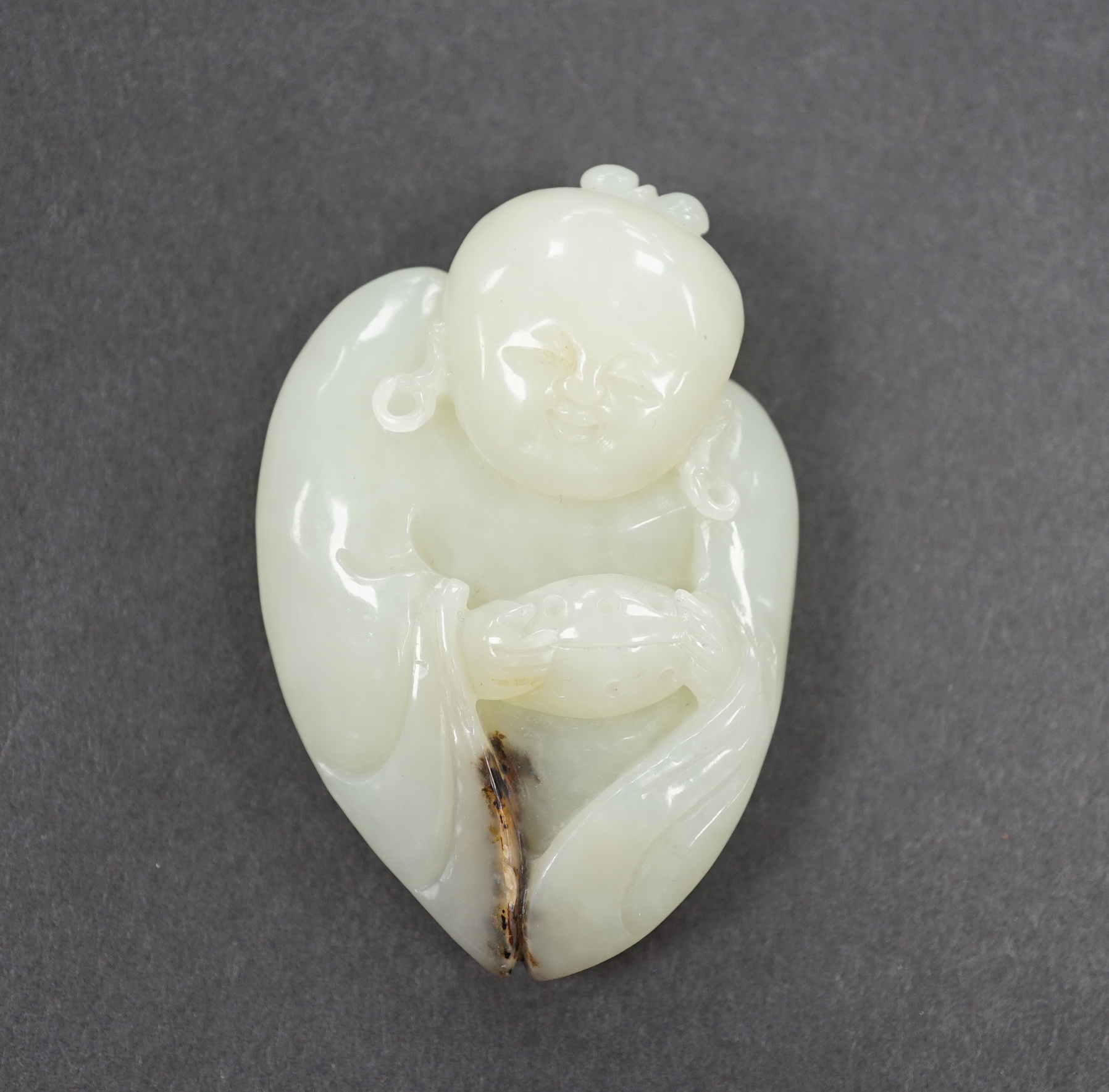 A Chinese pale celadon jade carving of one of the He He Erxian, 6.5cm                                                                                                                                                       