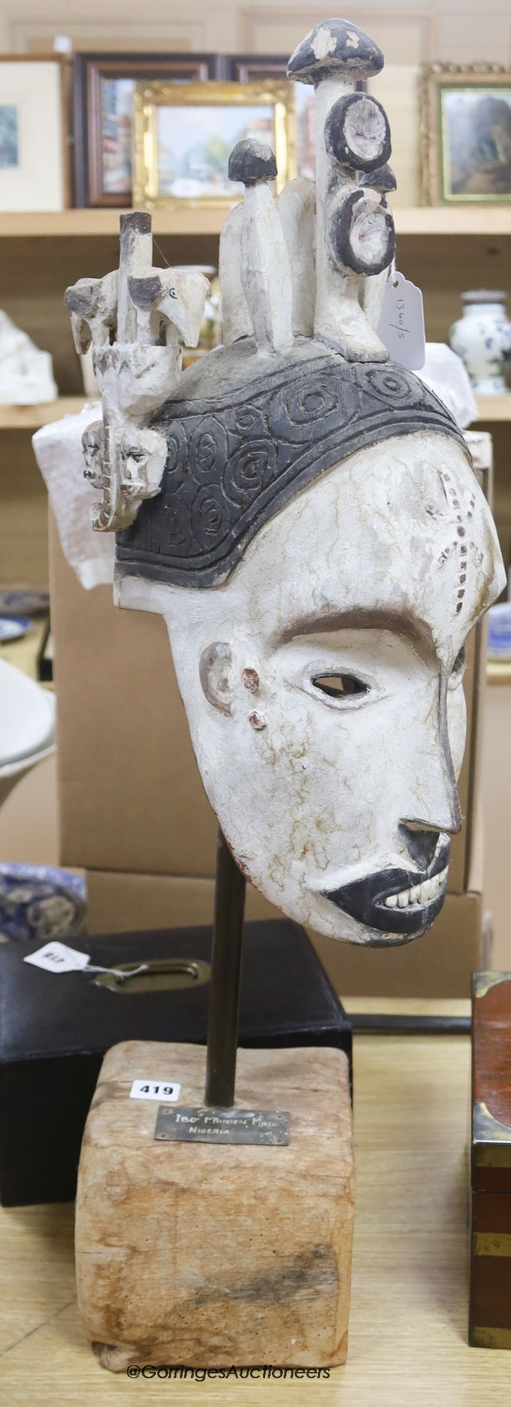 A Nigerian Ibo Maiden style mask, on stand, height 79cm                                                                                                                                                                     