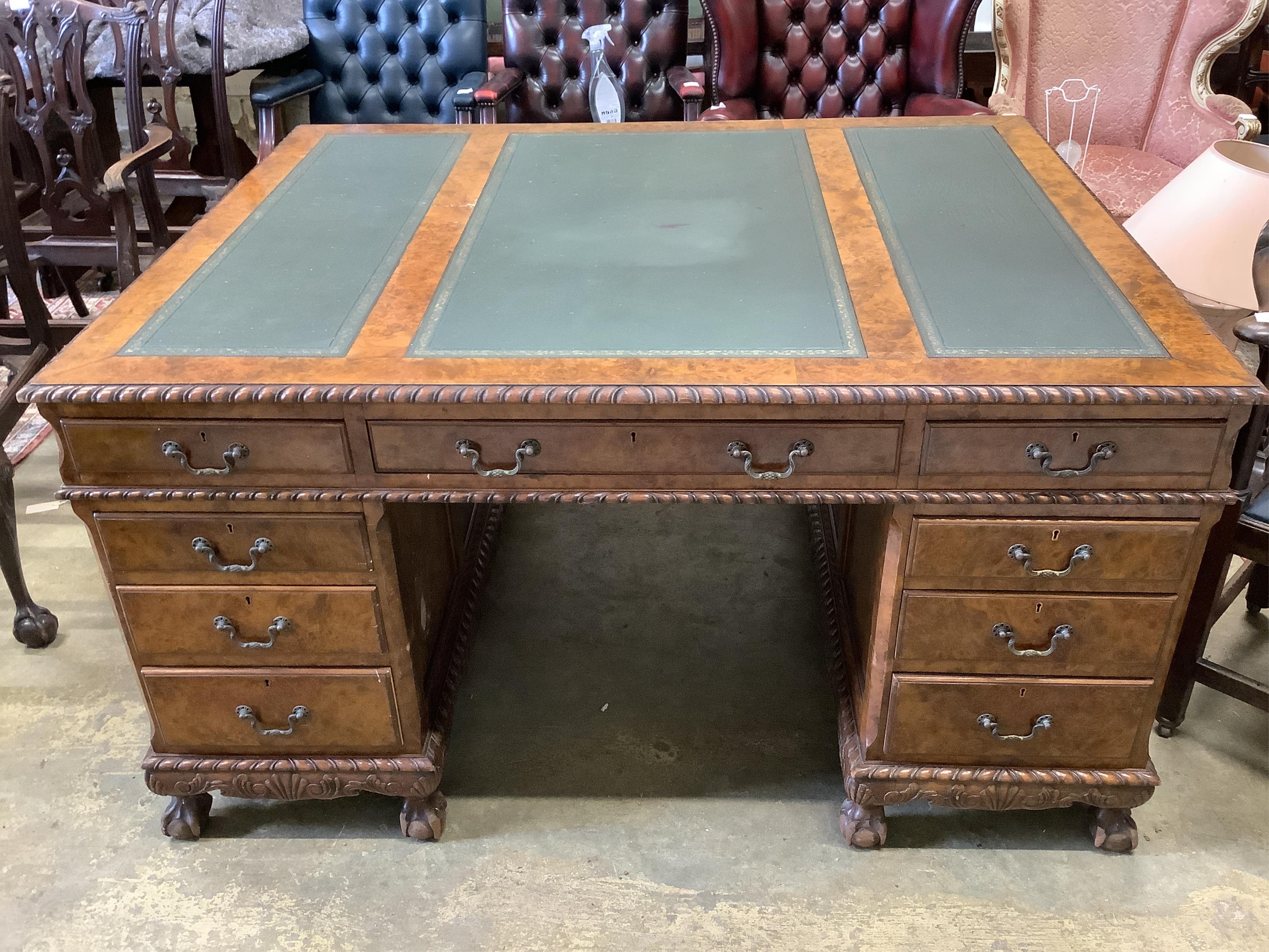 An early 20th century figured walnut partner's desk, width 152cm, depth 121cm, height 82cm. Condition - fair to good                                                                                                        