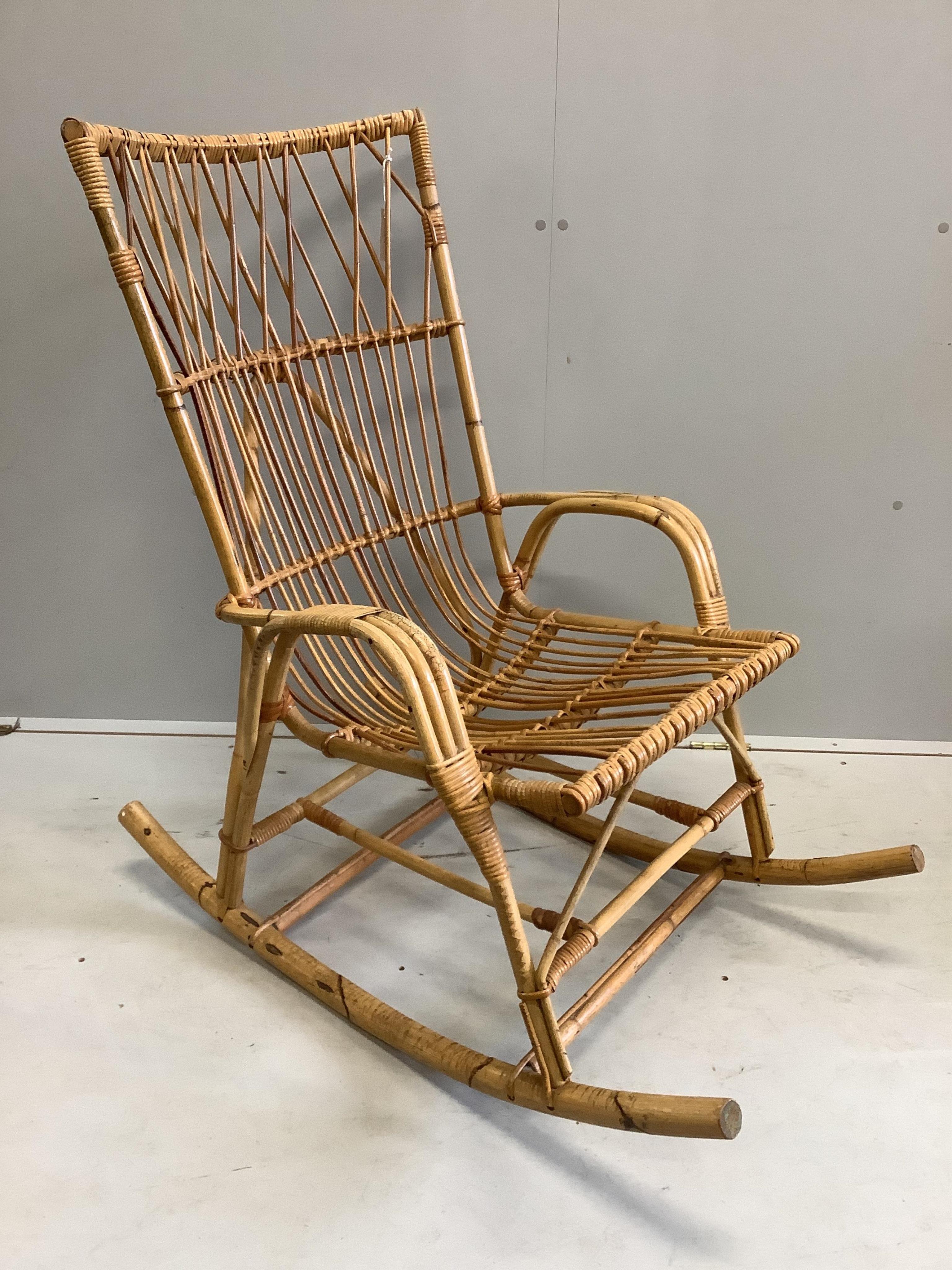 A vintage caned bamboo rocking chair, width 61cm, height 108cm. Condition - fair                                                                                                                                            