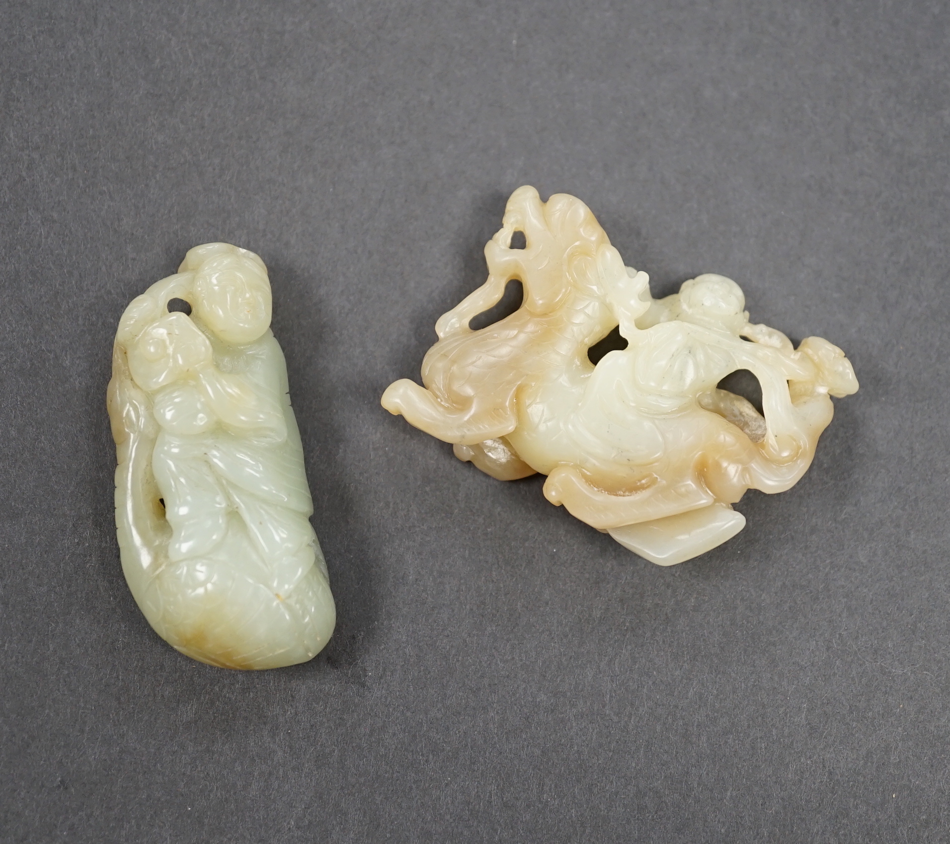 A Chinese pale celadon jade luohan riding a beast and a man on a leaf, 5.5cm                                                                                                                                                