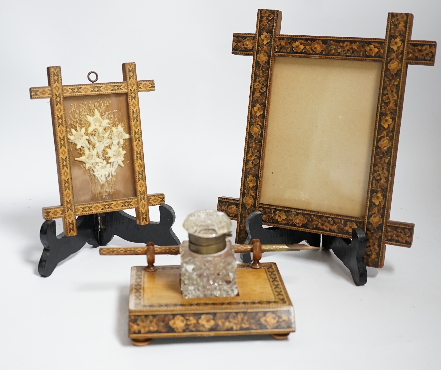 A Tunbridge ware inkstand with cut glass bottle and pen, together with two frames, largest 22.5cm high                                                                                                                      
