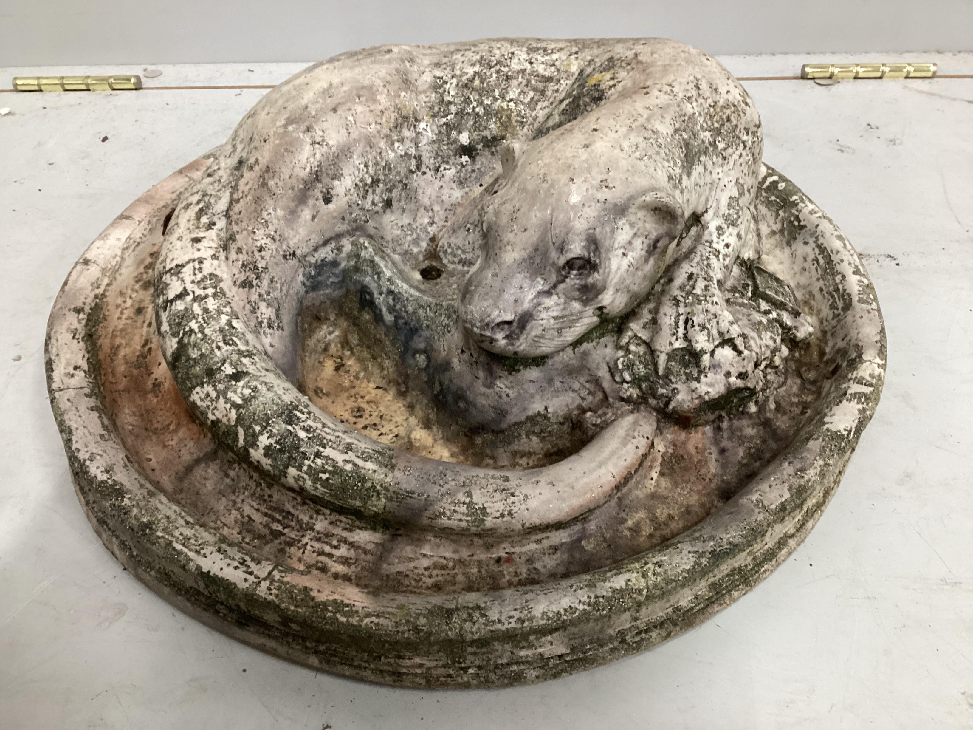 A circular stone otter fountain head, diameter 42cm                                                                                                                                                                         