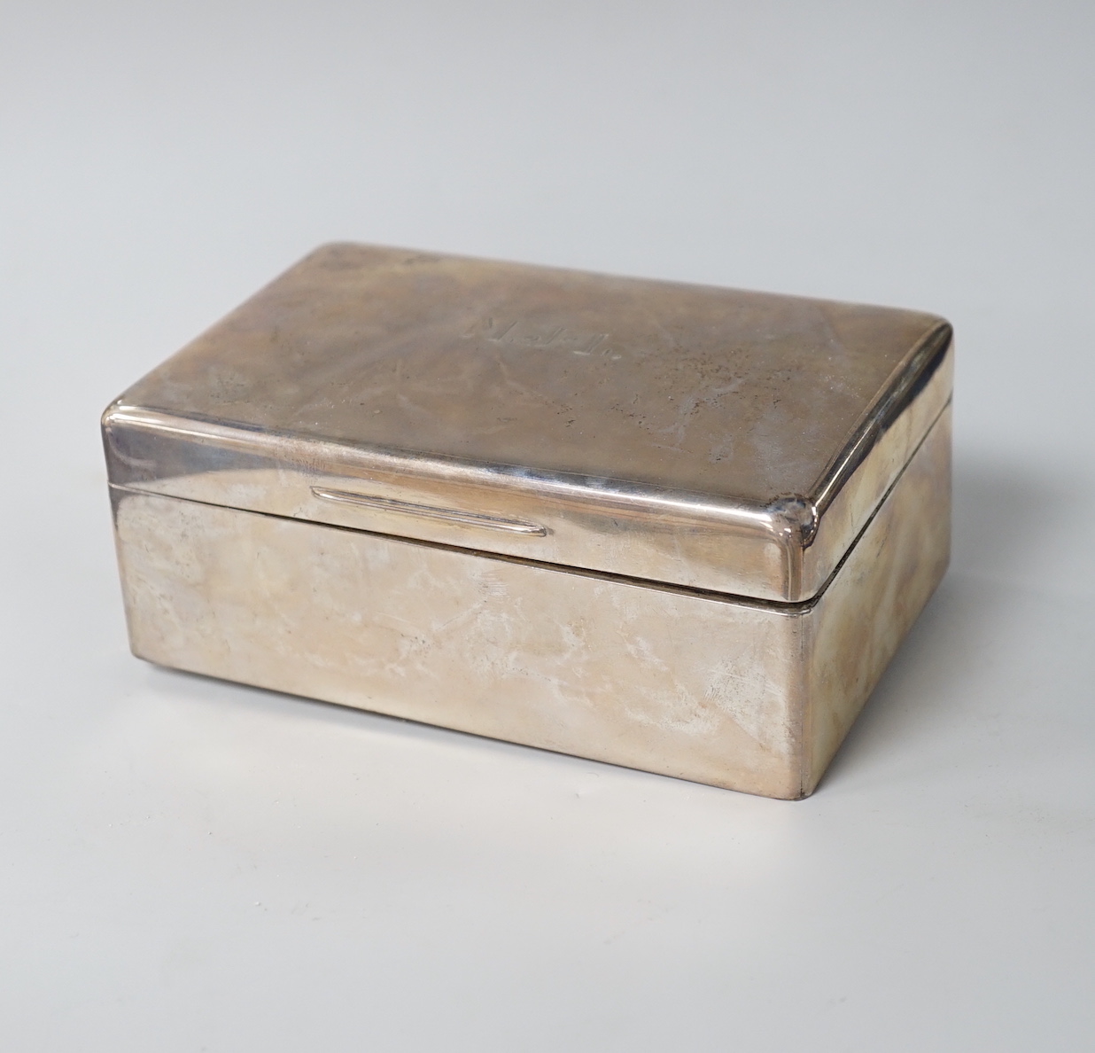 A George VI plain rectangular silver cigarette box with initials MJL, Mappin & Webb, London 1945, 14cm, gross 479 grams                                                                                                     