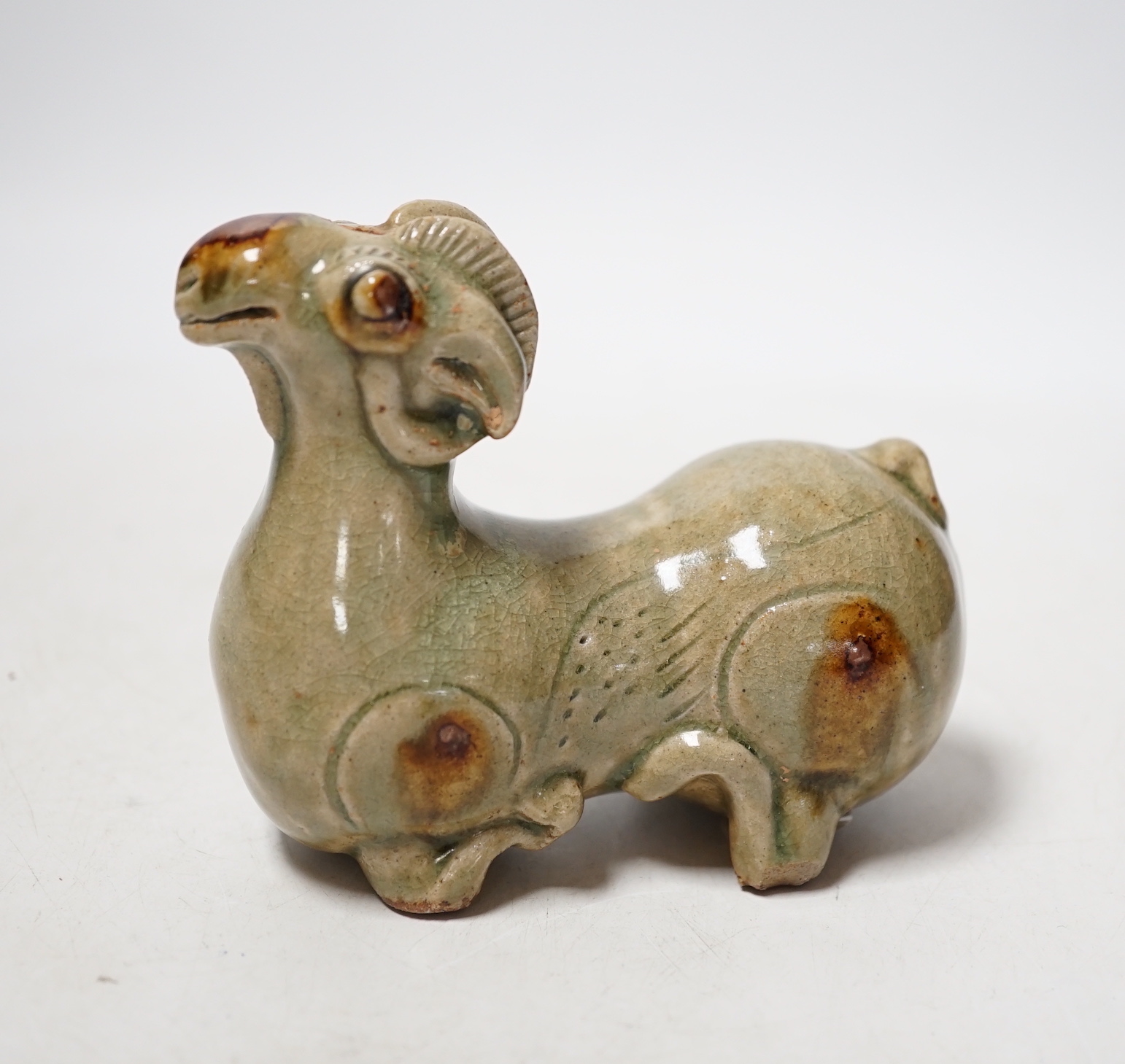 A Chinese Yue type green glazed model of a ram, 10cm wide                                                                                                                                                                   