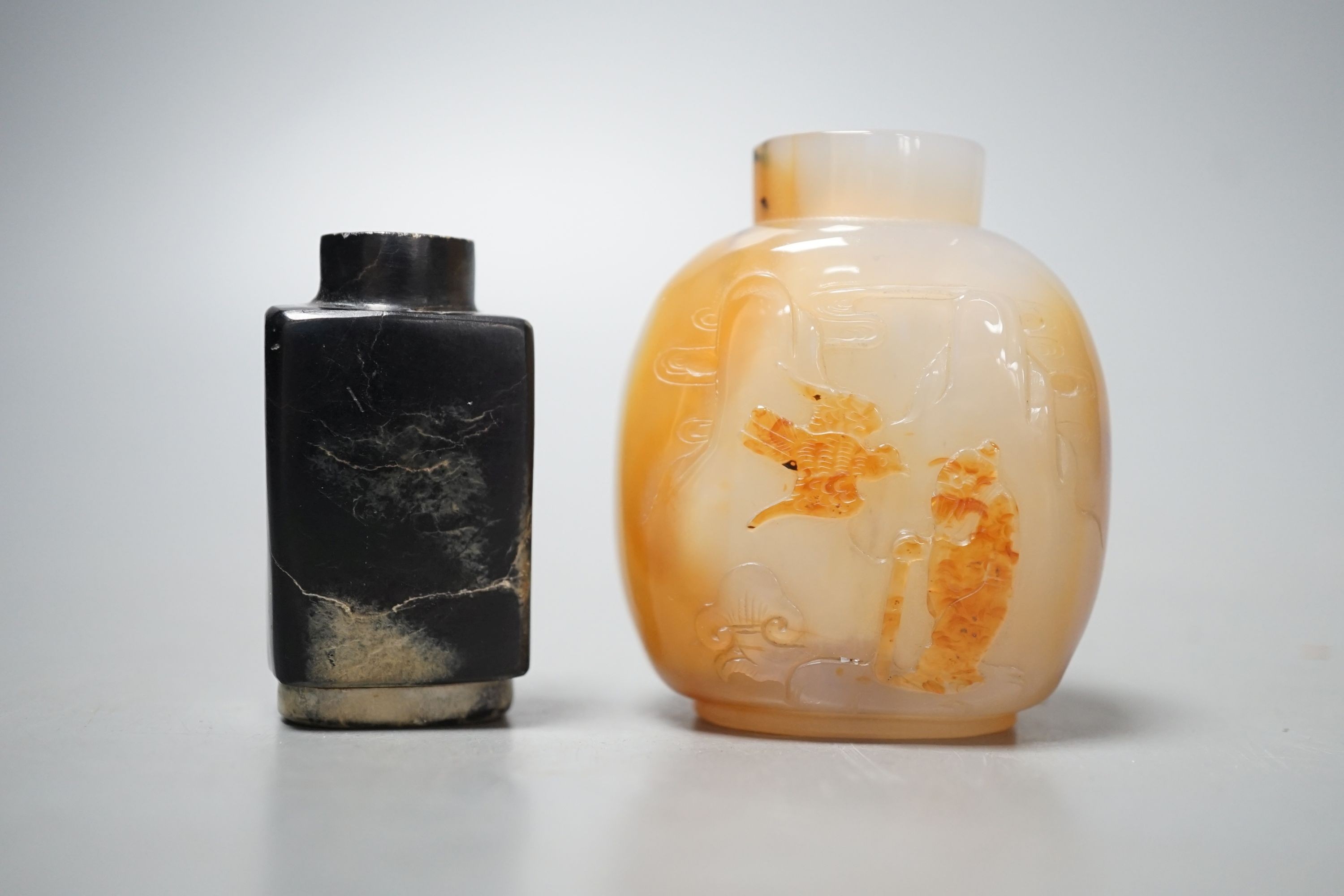 A Chinese white and black jade snuff bottle and a similar agate snuff bottle                                                                                                                                                