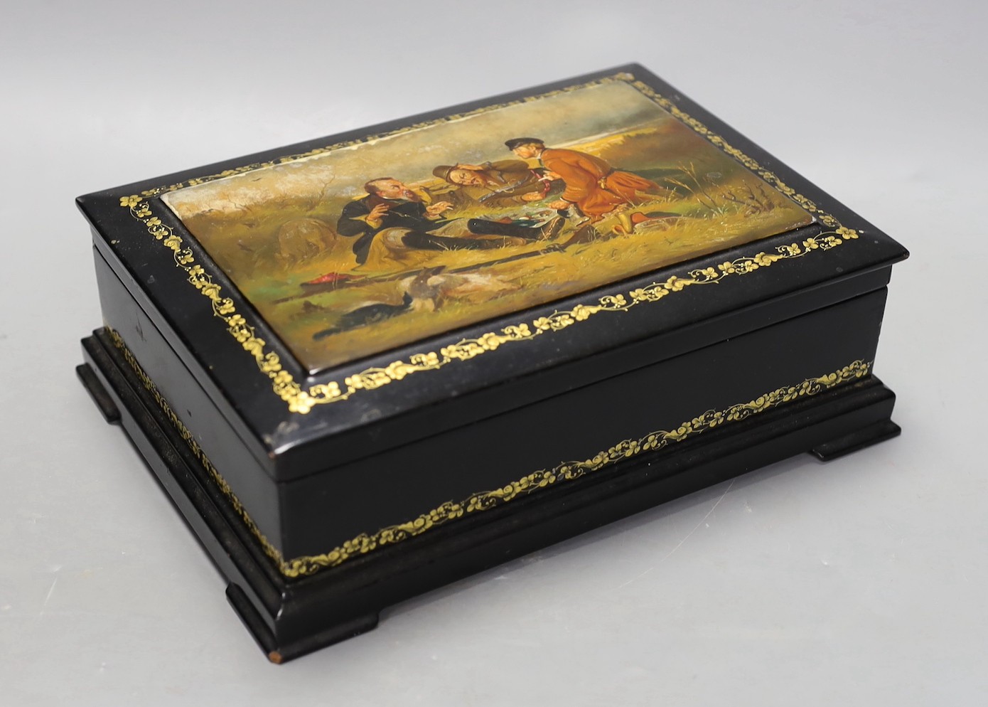 A Russian painted and ebonised box, 23cms wide                                                                                                                                                                              