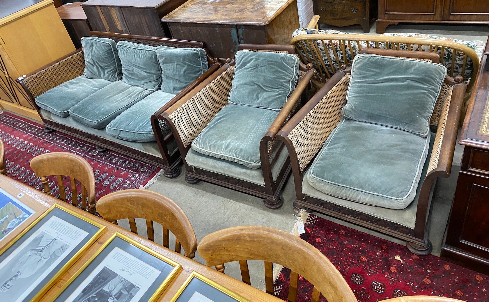 An early 20th century mahogany single caned three piece bergere suite, settee length 182cm, depth 77cm, height 68cm                                                                                                         