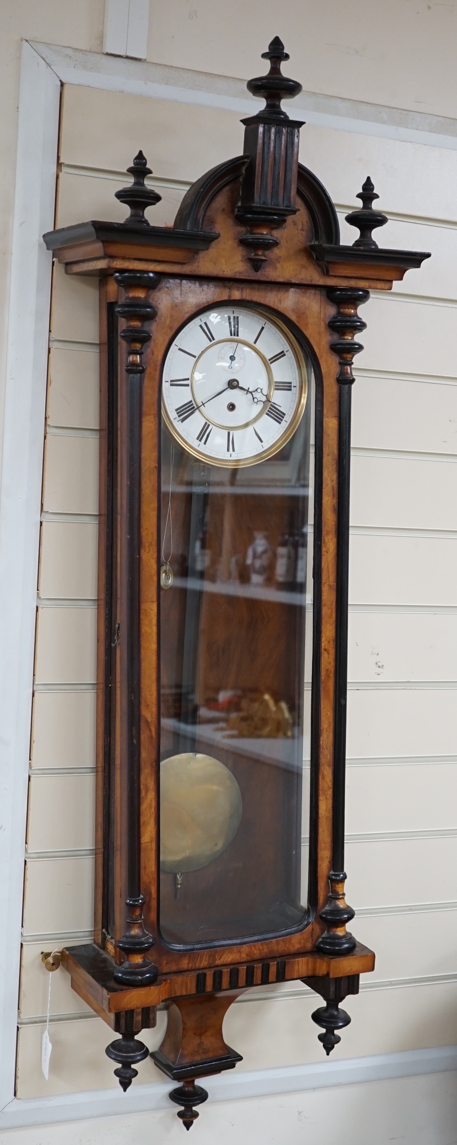 A walnut and ebony cased Vienna wall clock, 130cms high                                                                                                                                                                     