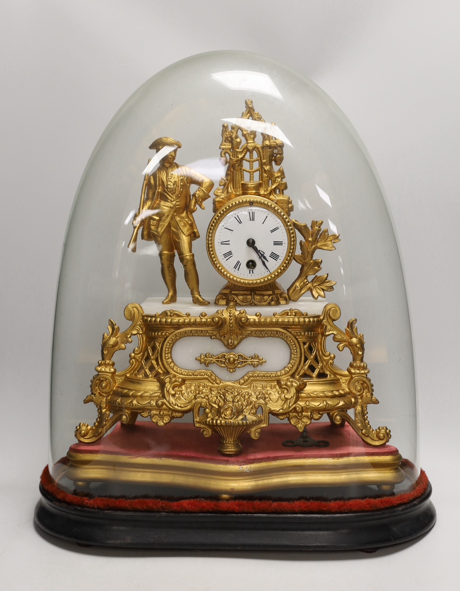 A French gilt metal mantel clock under dome. Overall 53cm tall                                                                                                                                                              