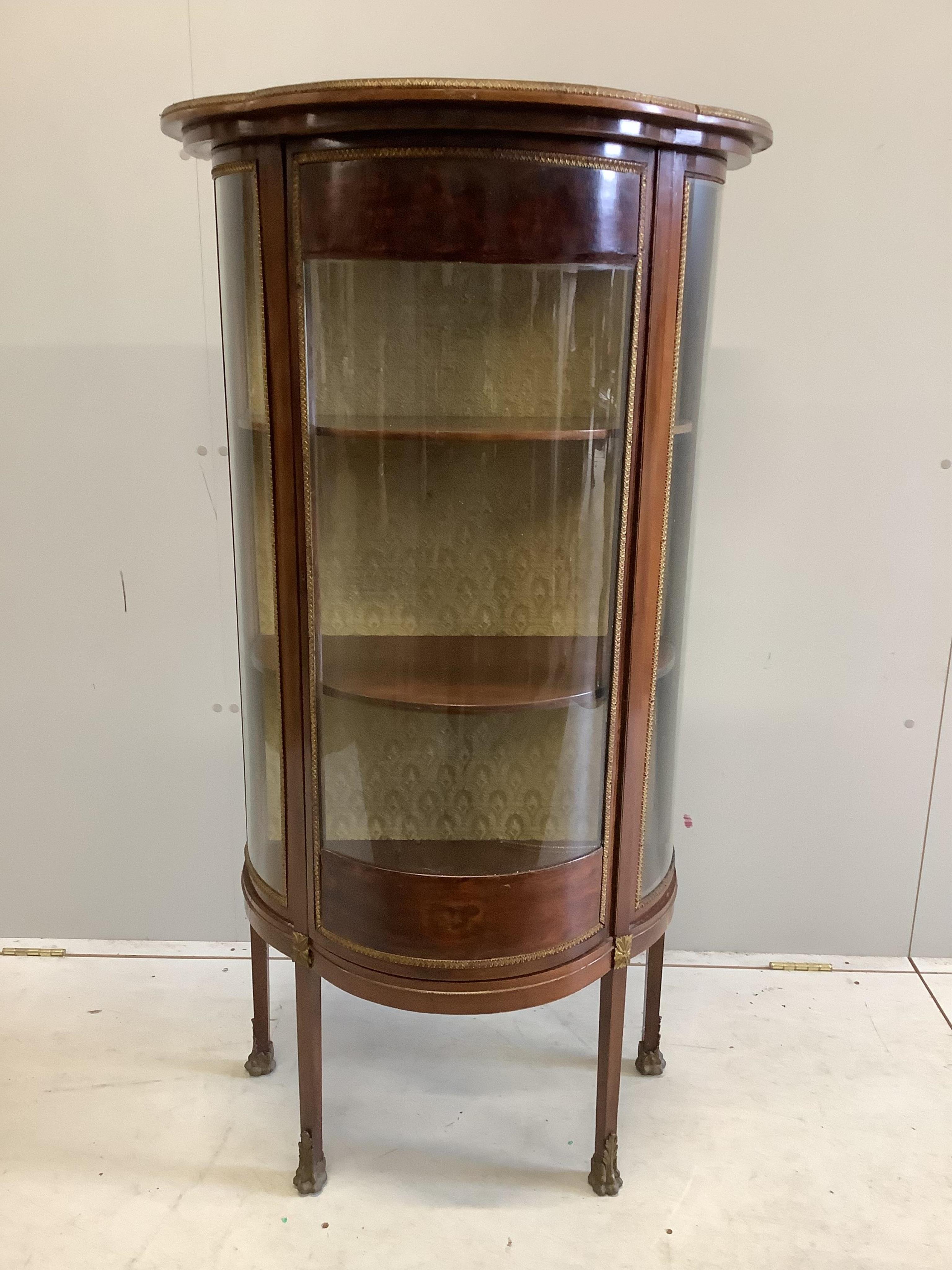 A Louis XVI style bowfront vitrine, width 69cm, depth 40cm, height 133cm. Condition - fair                                                                                                                                  