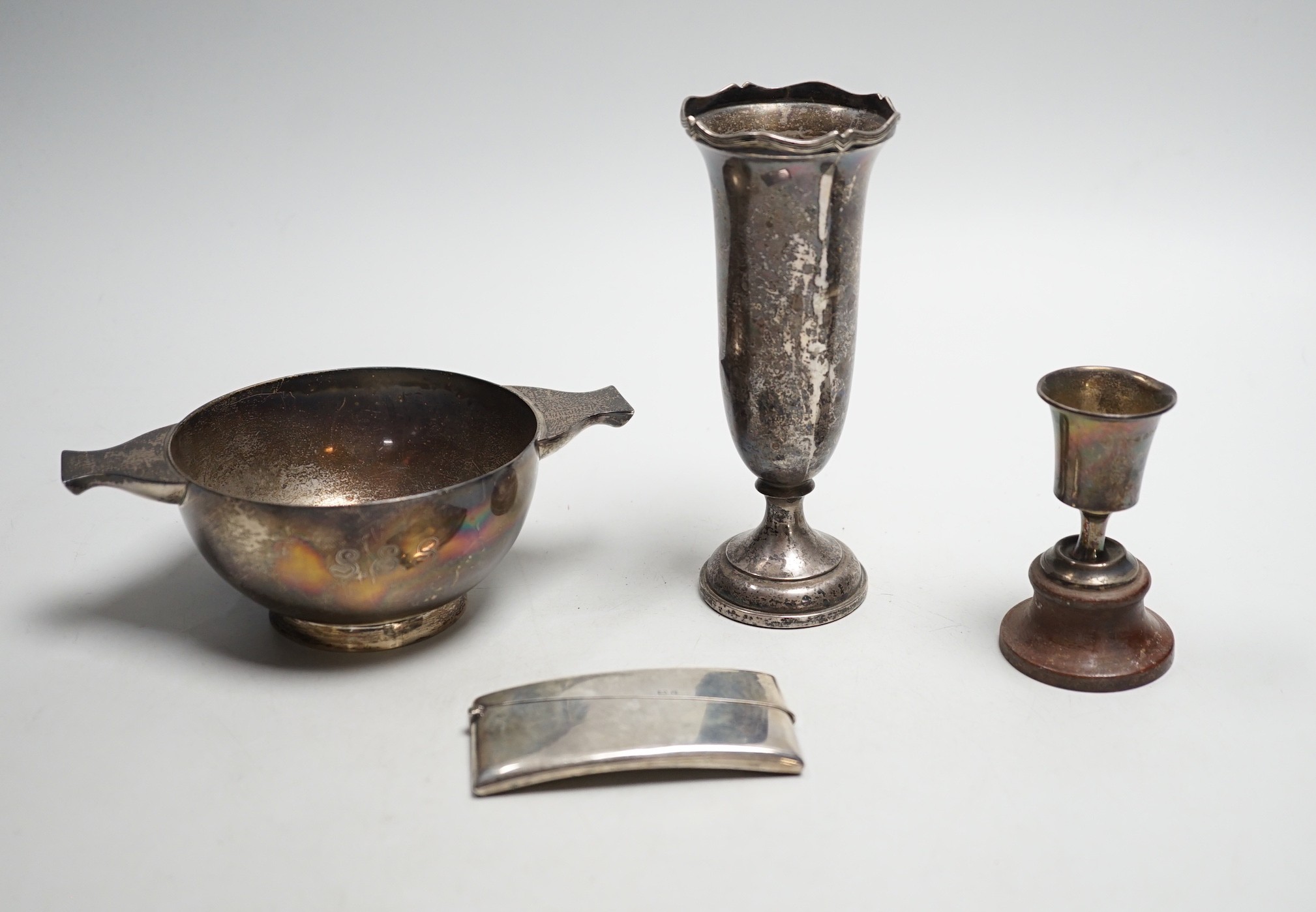 A George V silver two handled bowl, by Sebastian Garrard, London, 1926, 15.5cm, 6.5oz, a silver card case, small silver cup and a Ceylonese white metal posy vase.                                                          