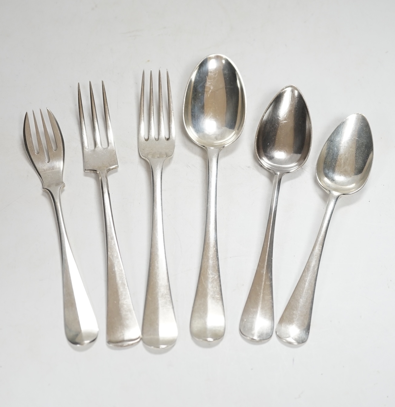 A large quantity of assorted Dutch 833 standard white metal flatware, comprising sixty eight items, 115.4oz, together with seven items of silver plated flatware.                                                           
