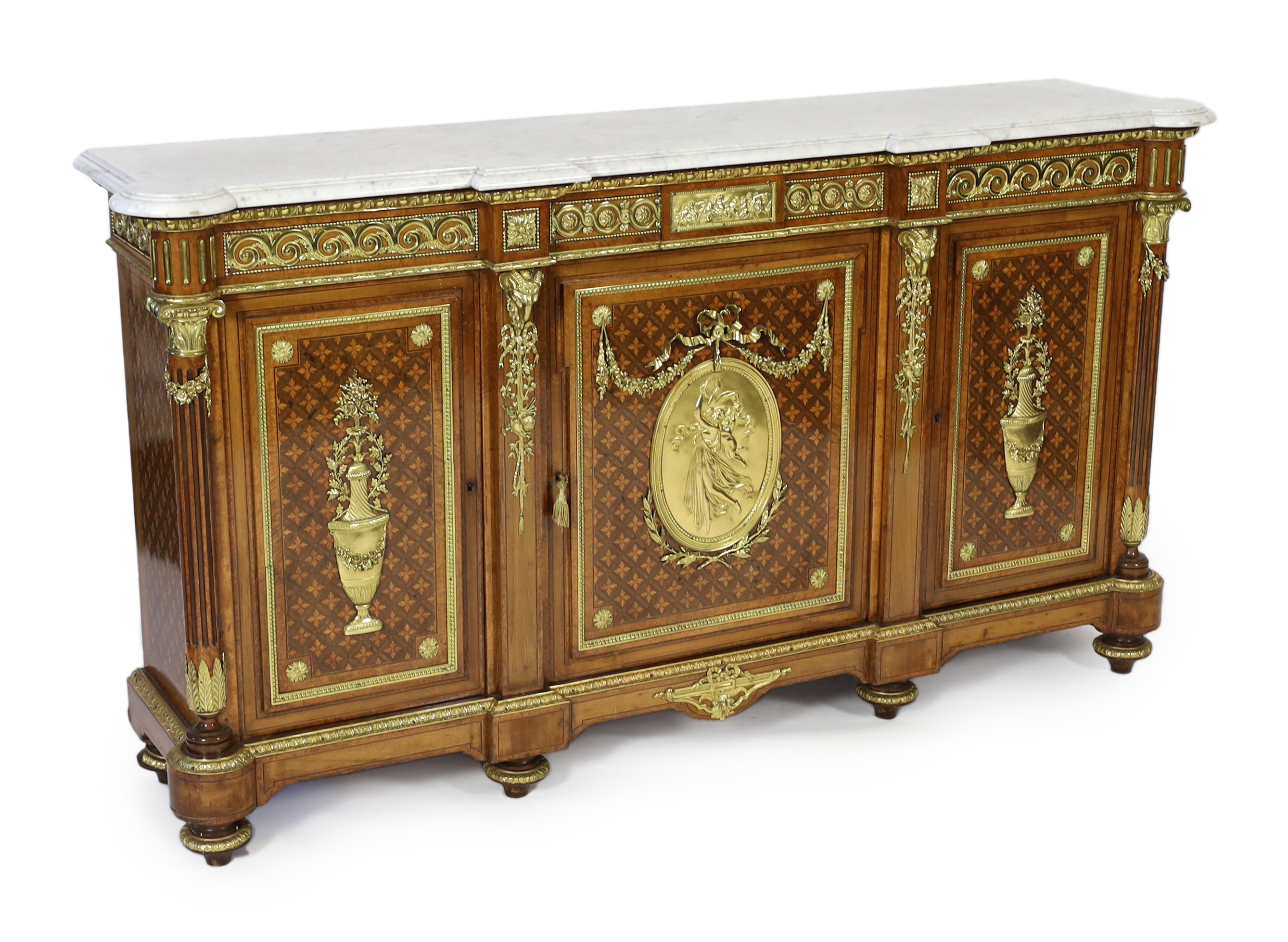 A Louis XVI style amboyna, tulipwood and harewood marquetry side cabinet, in the manner of Adam Weisweiler (1744-1820), 210cm wide, 48cm deep, 115cm high, Please note this lot attracts an additional import tax of 5% on t