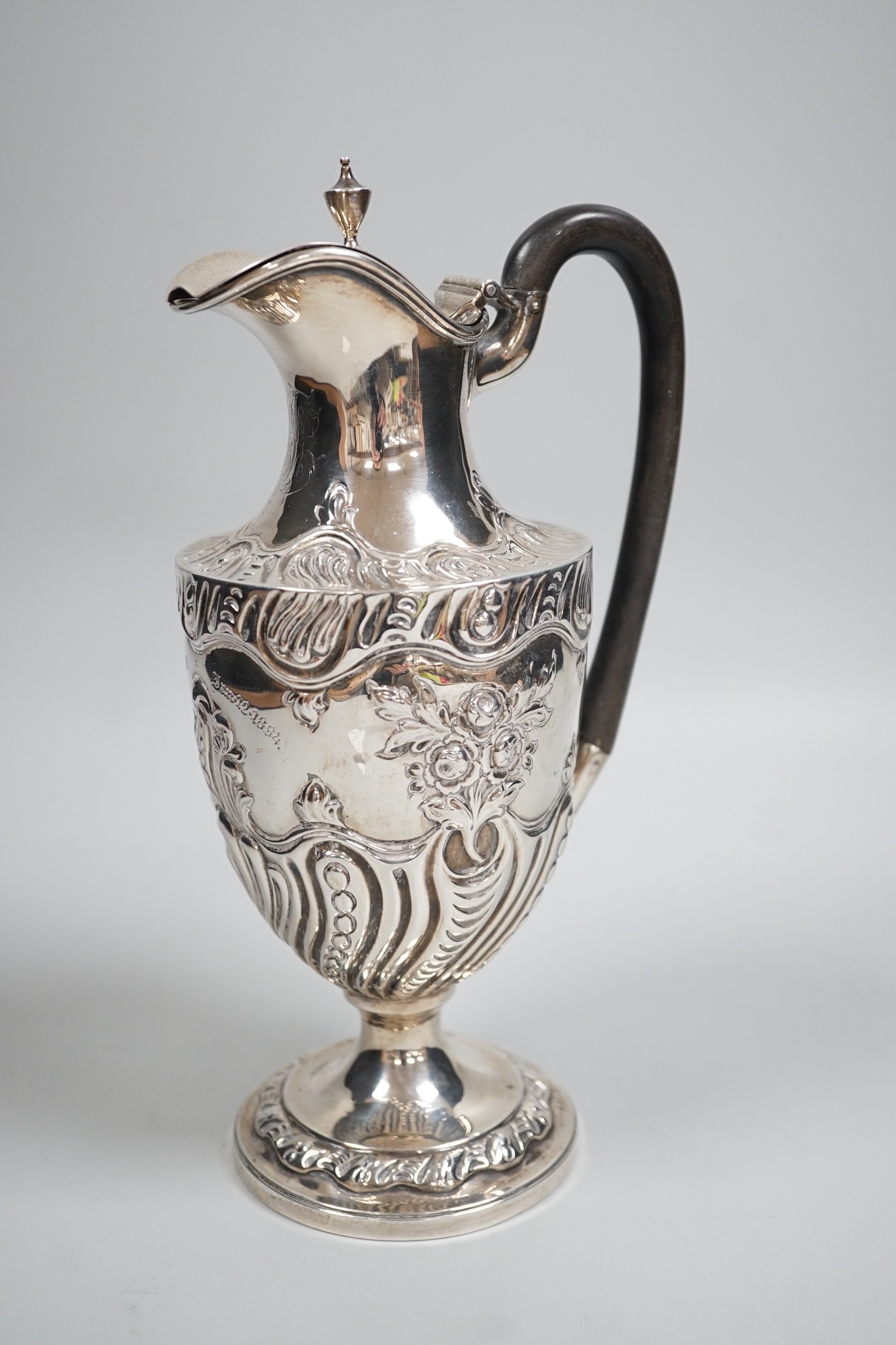 A late Victorian repousse silver pedestal hot water jug, Charles Stuart Harris, London, 1893, height 25cm, gross weight 13.3oz.                                                                                             