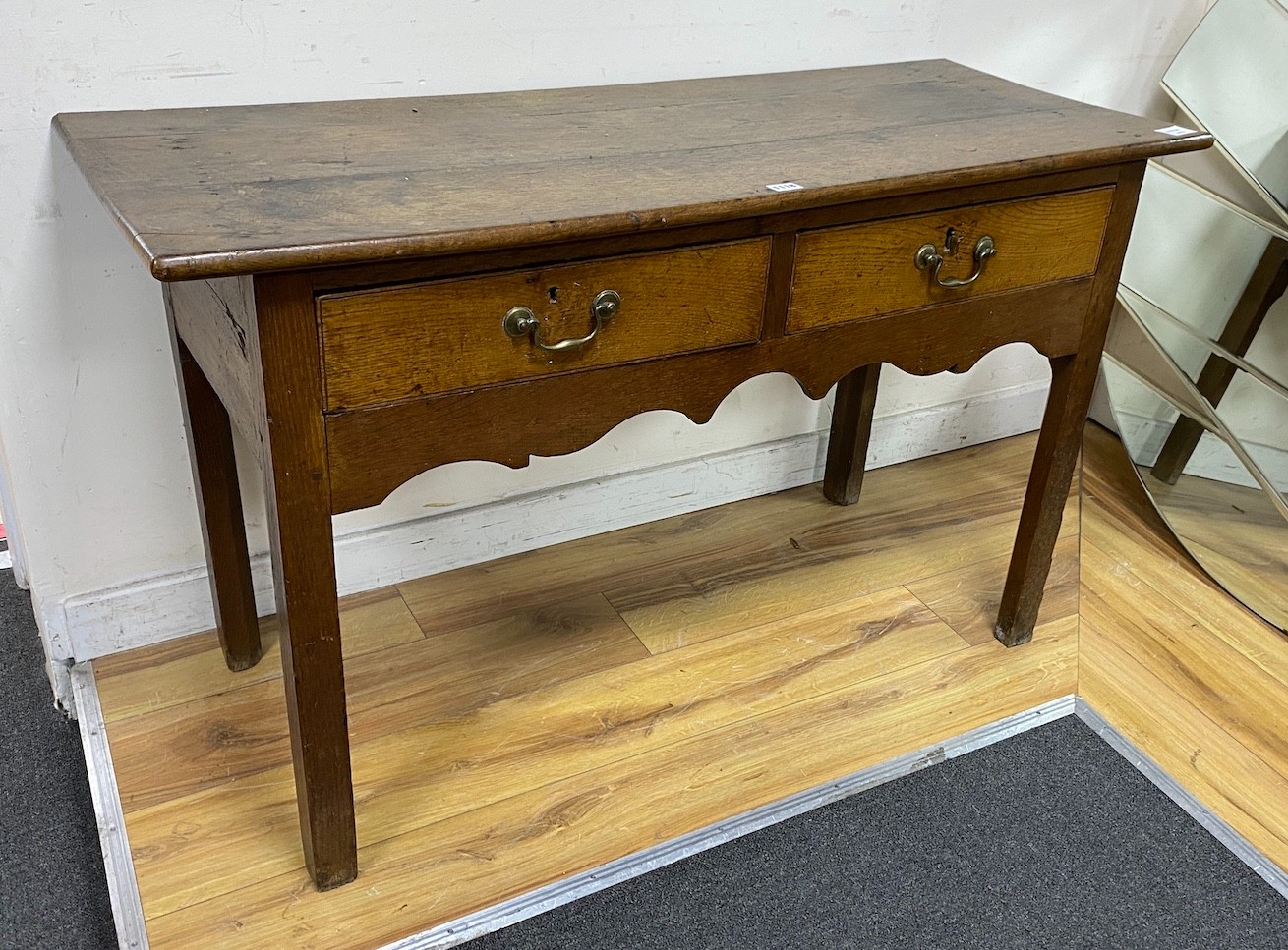 A late 18th century oak two drawer side table, width 120cm, depth 48cm, height 72cm                                                                                                                                         