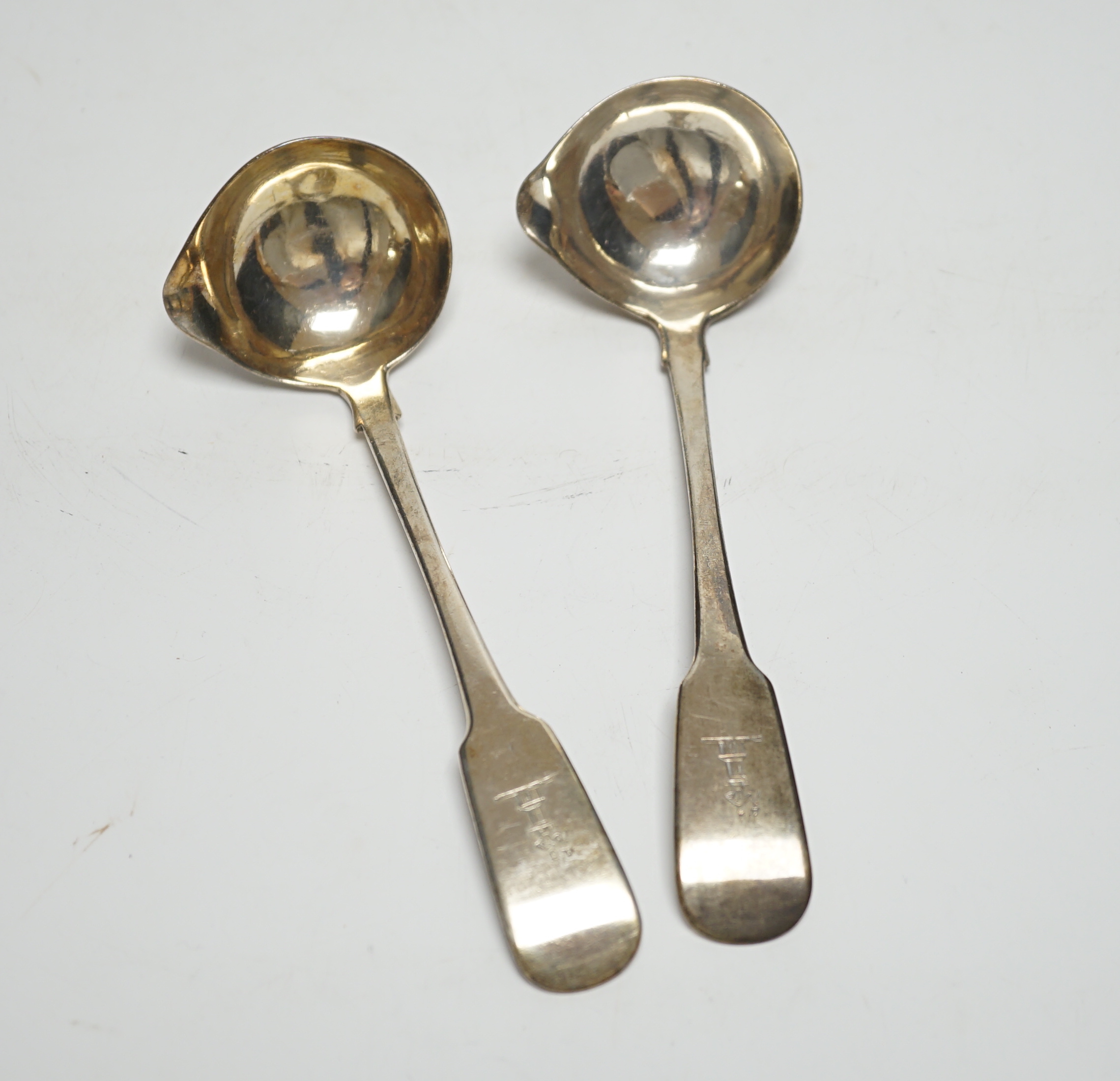 A pair of George IV Irish silver fiddle pattern sauce ladles, Lawrence Nowlan, Dublin, 1825, 15.8cm.                                                                                                                        
