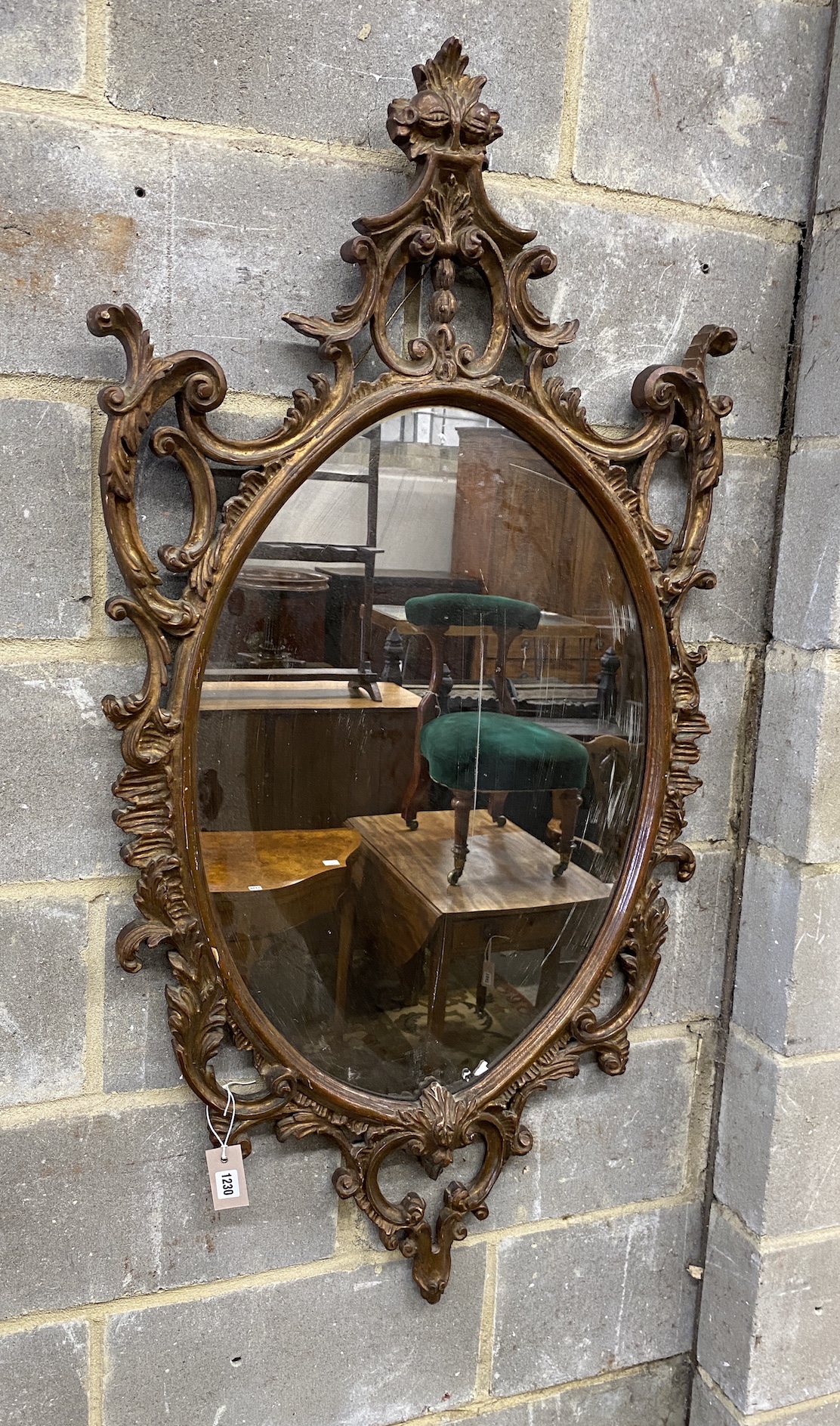 A Victorian style oval composition carved wall mirror, width 66cm, height 130cm                                                                                                                                             