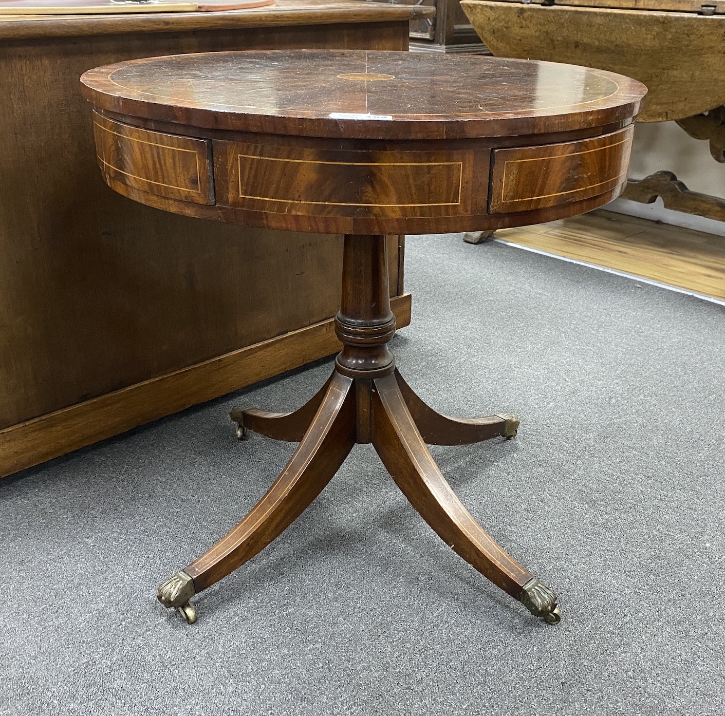 A George III style circular mahogany drum table with segmented veneered top, diameter 76cm, height 73cm                                                                                                                     