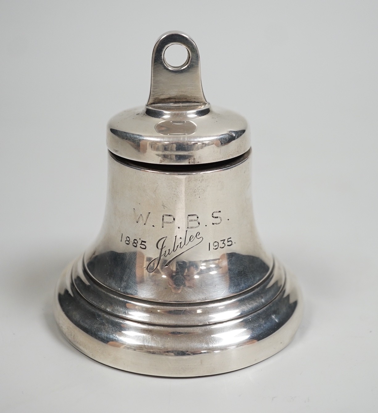 A George V silver mounted inkwell, modelled as a bell, Birmingham, 1935, height 97mm.                                                                                                                                       