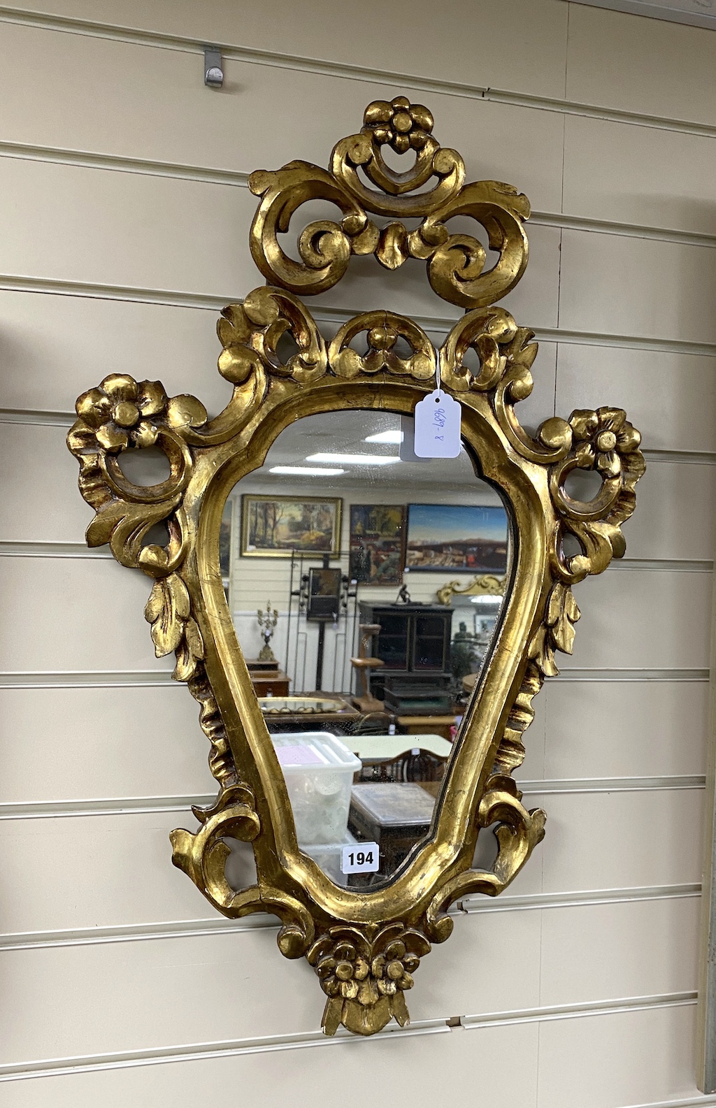 A giltwood cartouche wall mirror, height 74cms.                                                                                                                                                                             