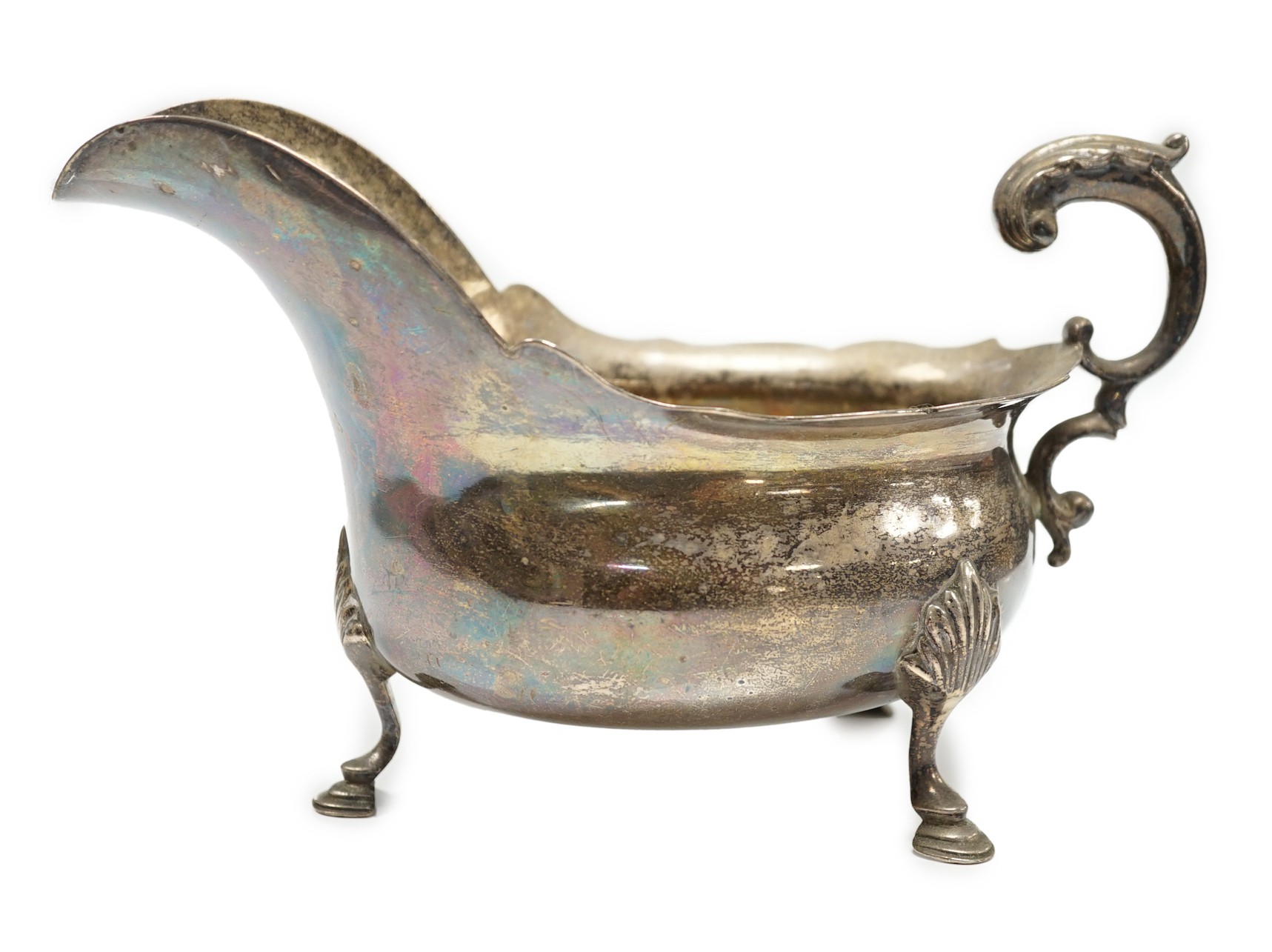 A late Victorian silver sauce boat, with flying scroll handle, Charles Boyton, London, 1897, length 21.6cm, 14.1oz.                                                                                                         