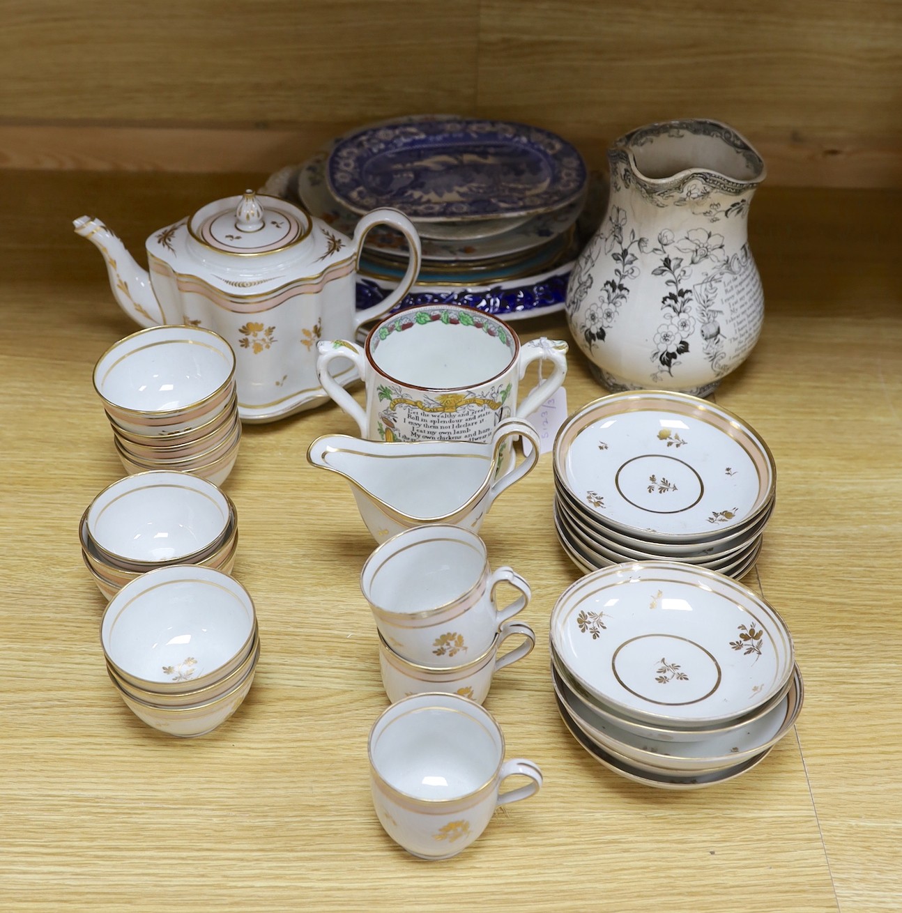 A 19th century Harvest jug and mug, a Victorian gilt tea set and mixed plates and a platter, jug 19 cms high.                                                                                                               