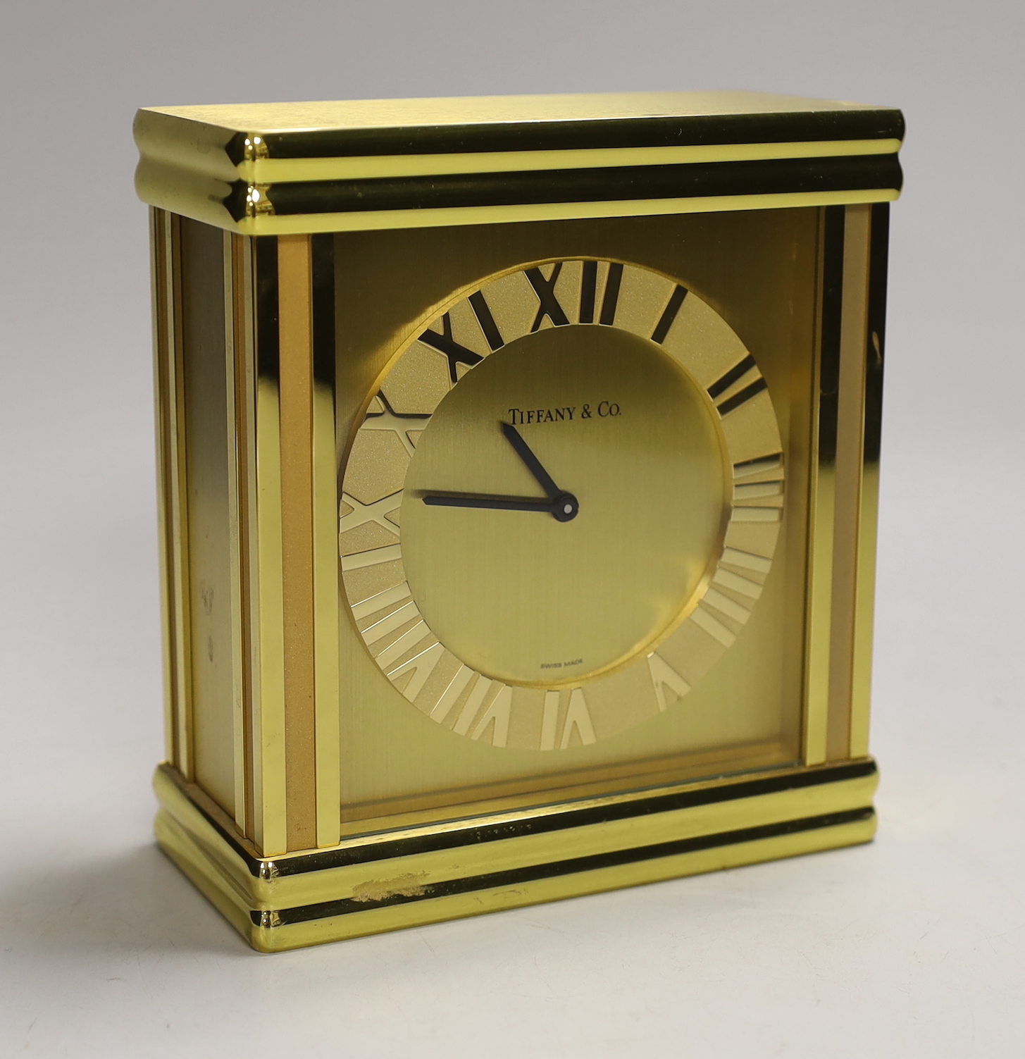 A Tiffany & Co. Swiss made brass clock, 14cm wide, 15.5cm high                                                                                                                                                              