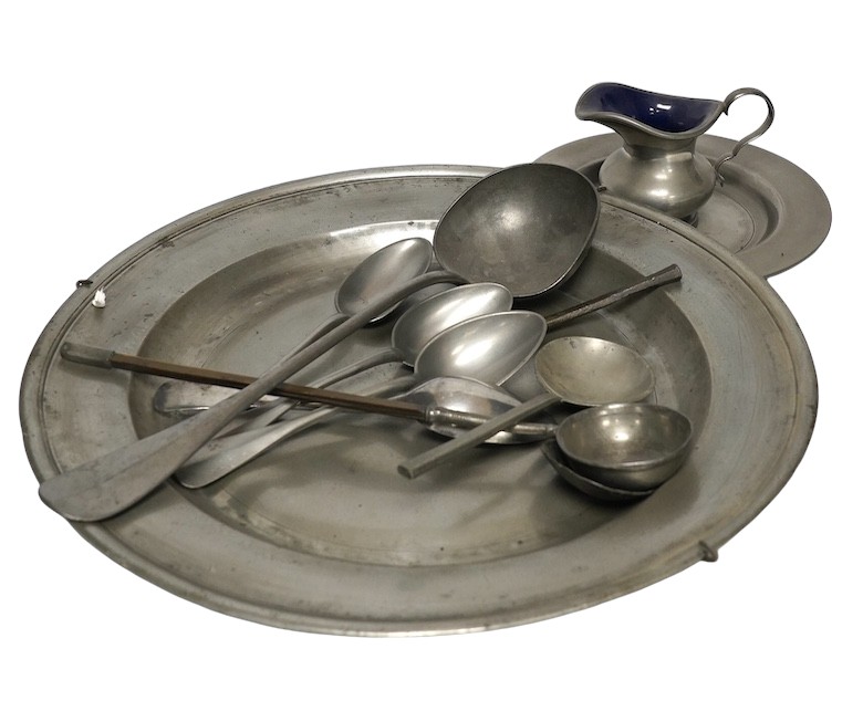 A quantity of 18th century and later pewter to include charger, warming plates and spoons, largest 39cm in diameter. Condition - mostly fair                                                                                