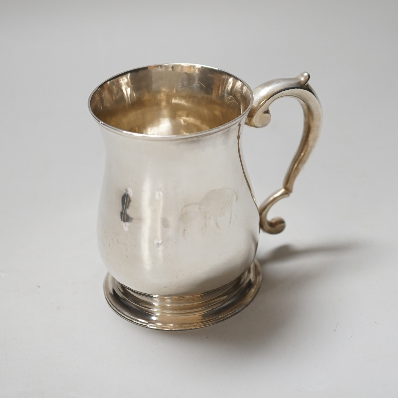 A George II silver baluster mug with scroll handle, makers mark rubbed, London 1752, 9cm, 160 grams                                                                                                                         