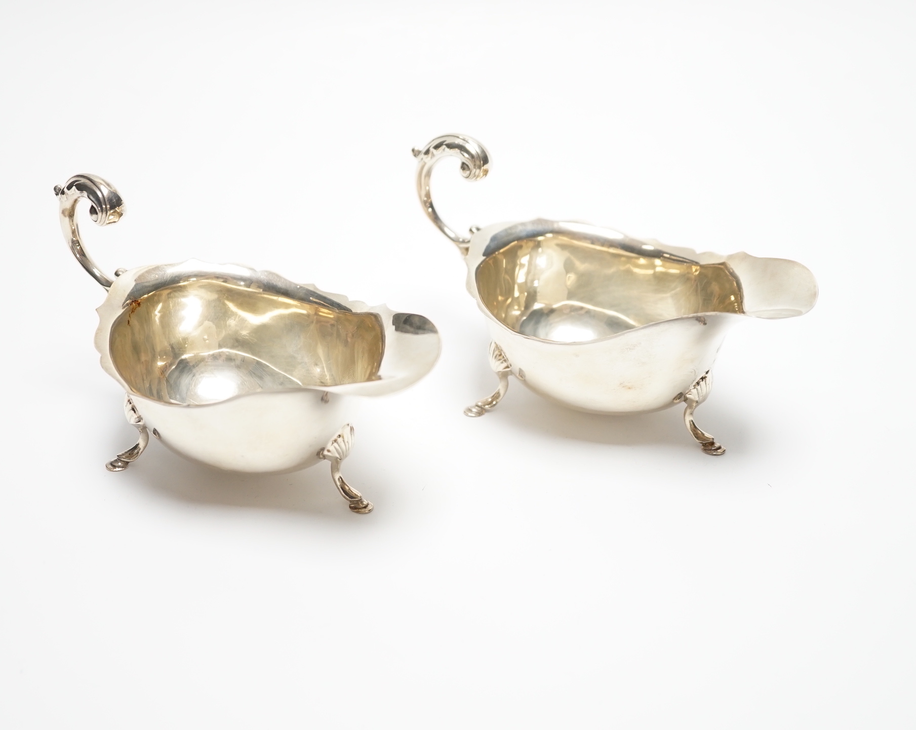 A pair of George V silver sauceboats, with flying scroll handles, S. Blanckensee & Sons Ltd, Birmingham, 1927, length 15cm, 4.7oz.                                                                                          