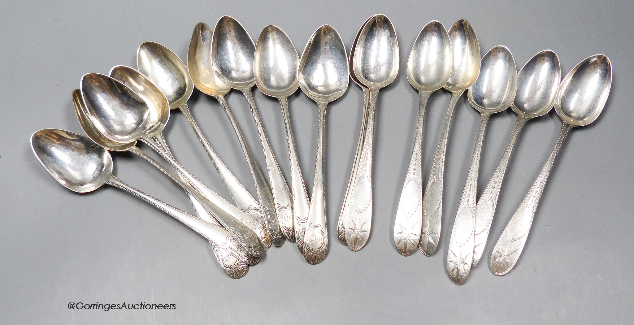 A matched set of ten mainly George III Irish silver feather edge dessert spoons including one Georgre II by John Hamilton, circa 1740, no date letters, other makers' mark IB?, 17cm and six other later Irish silver desser