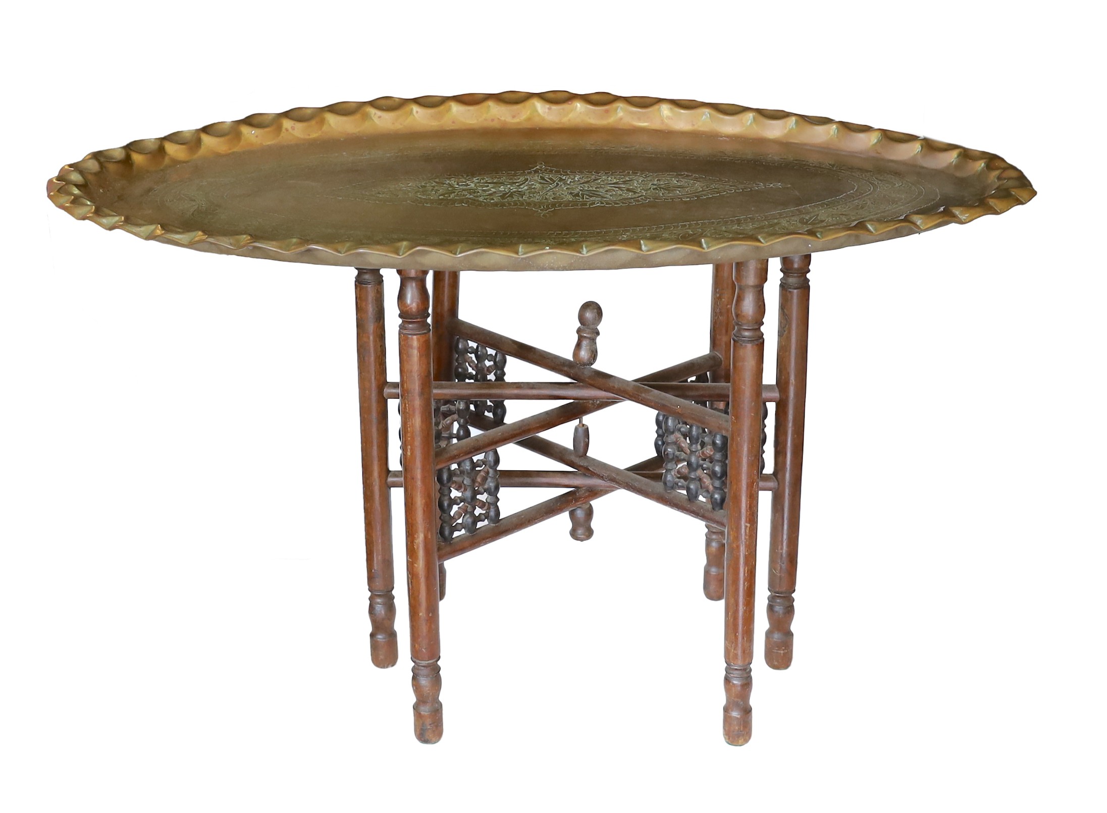 An unusually large early 20th century Indian brass oval tray top table with folding wooden underframe, 100 x 65cm. height 55cm                                                                                              