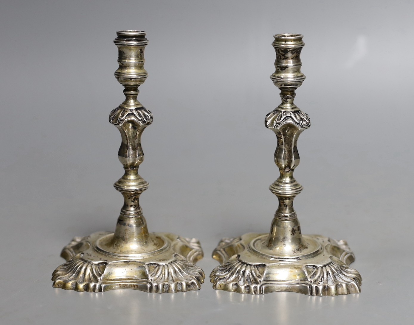 A pair of George V silver taper sticks, by Garrard & Co Ltd, London, 1934, 12.1cm, 10.7oz.                                                                                                                                  