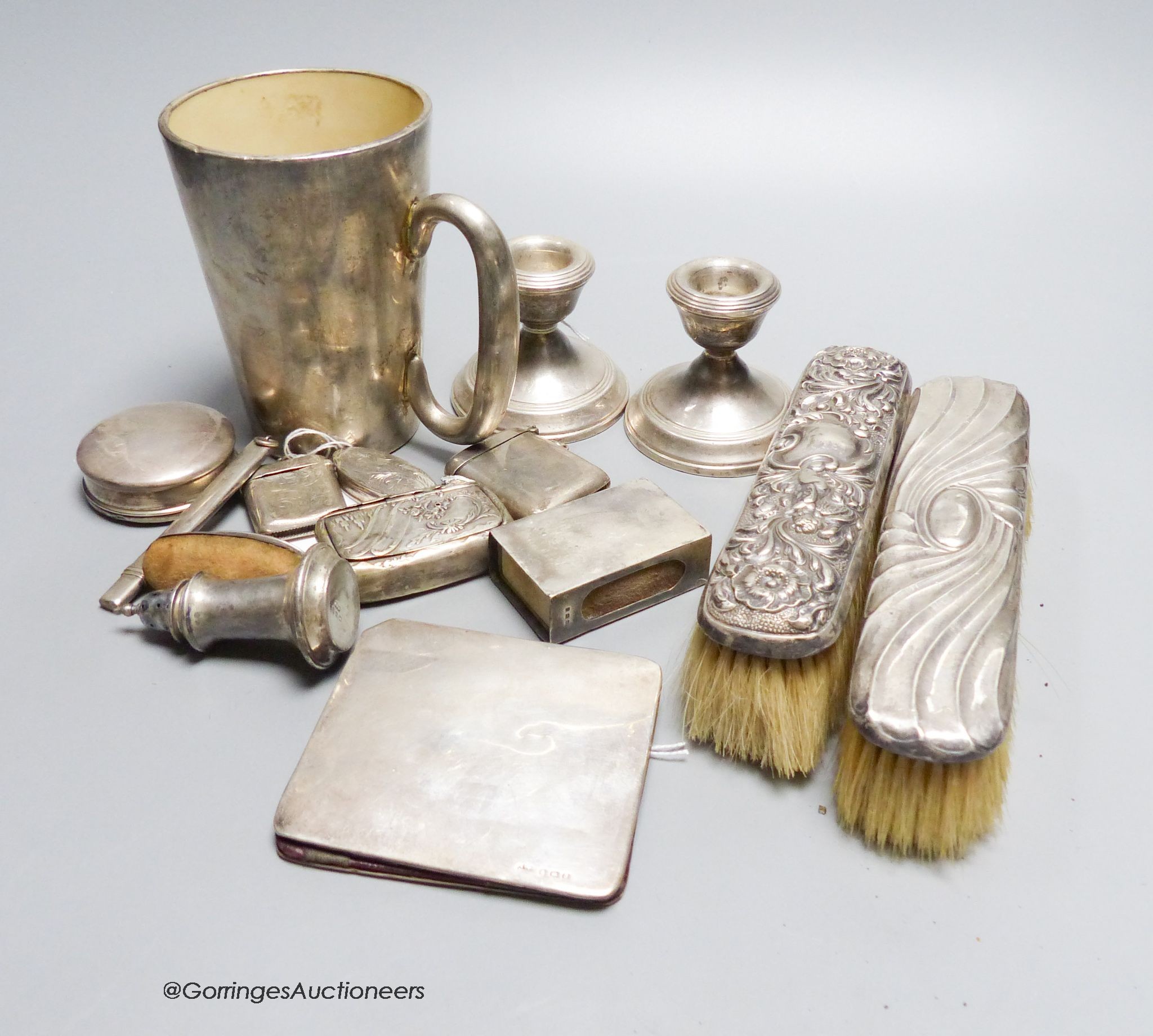 A pair of dwarf pillar candlesticks, a silver-mounted mug, a Georgian snuff box (a.f.), two vesta cases, a silver-mounted wallet, two small boxes, etc.                                                                     