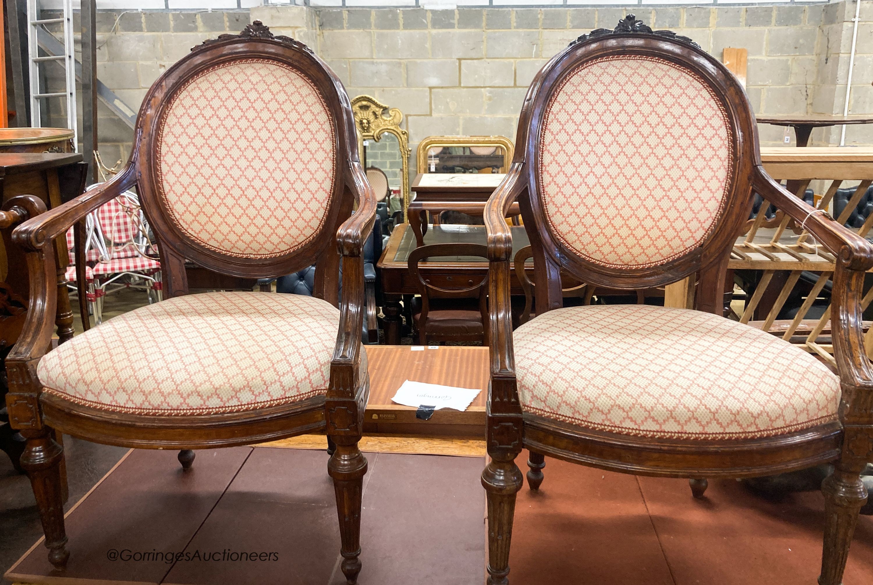 A pair of 19th century French walnut upholstered elbow chairs, W.62cm D.50cm H.102cm                                                                                                                                        