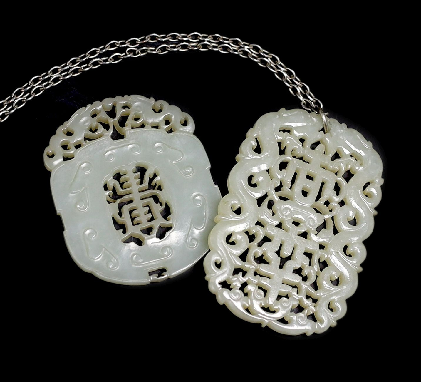 Two Chinese pale celadon jade openwork plaques, 19th century, 5.4 cm and 6.4 cm                                                                                                                                             