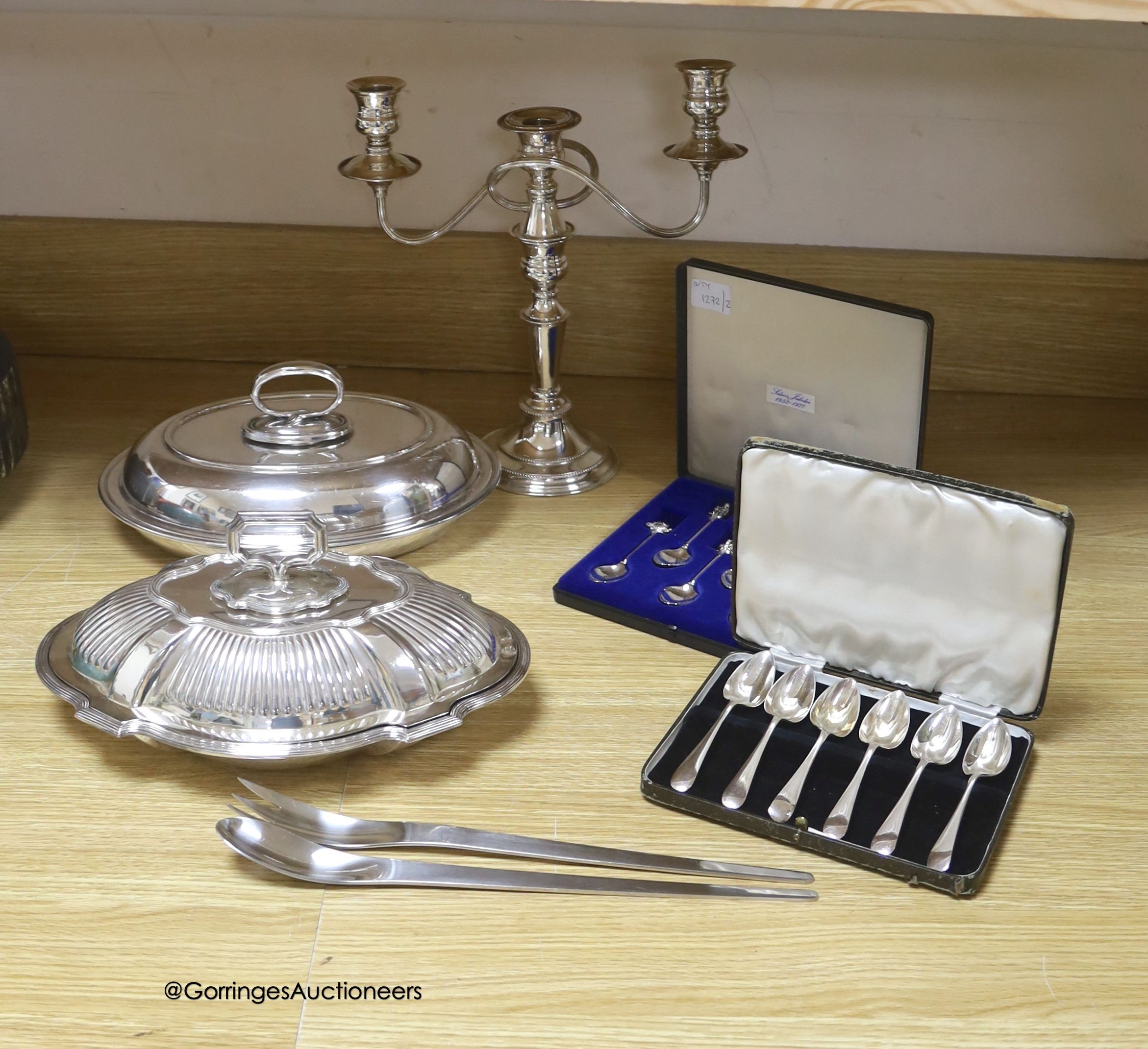 A group of plated ware including a pair of Georg Jensen salad servers                                                                                                                                                       