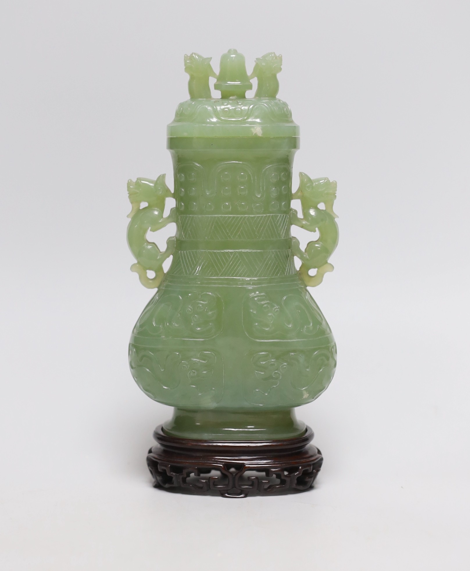 A Chinese carved bowenite jade vase and cover on hardwood stand, 23cm, with fitted case                                                                                                                                     