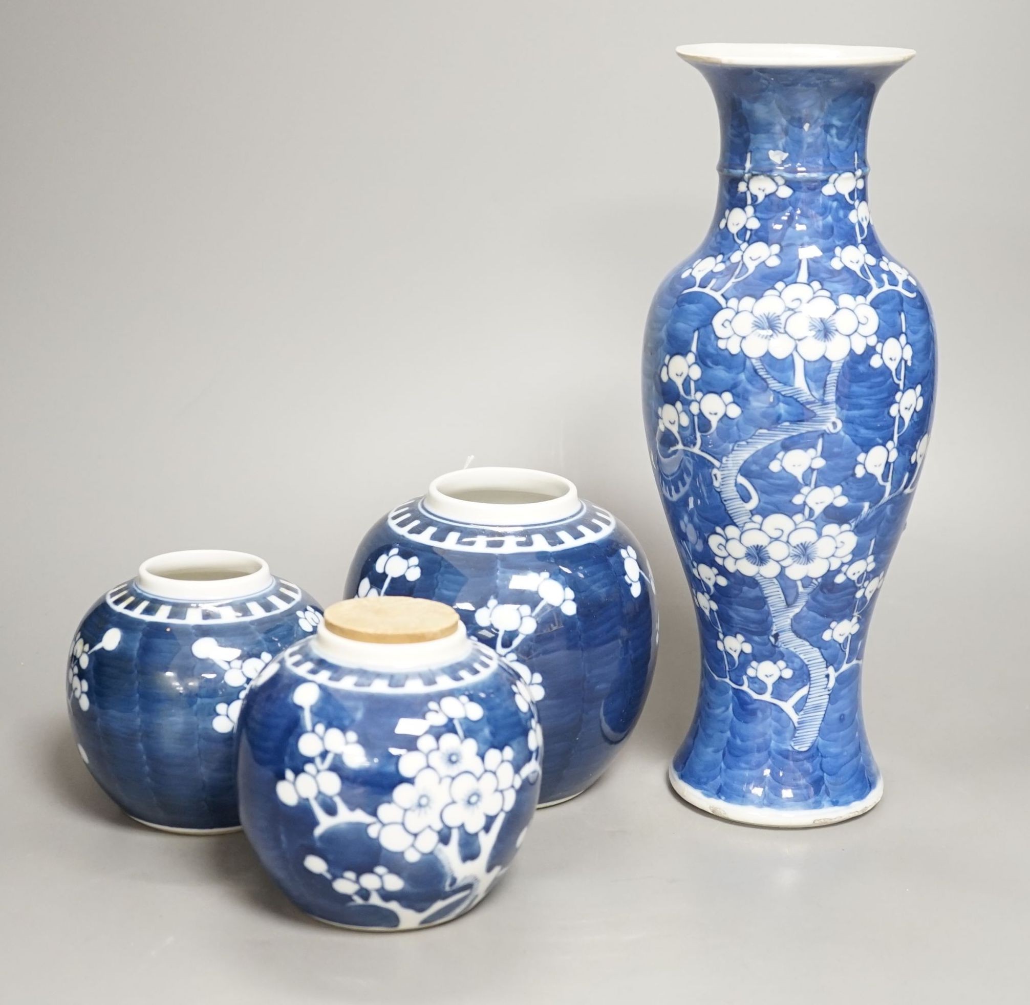 A Chinese blue and white prunus vase together with three similar jars. Vase height 30cm                                                                                                                                     