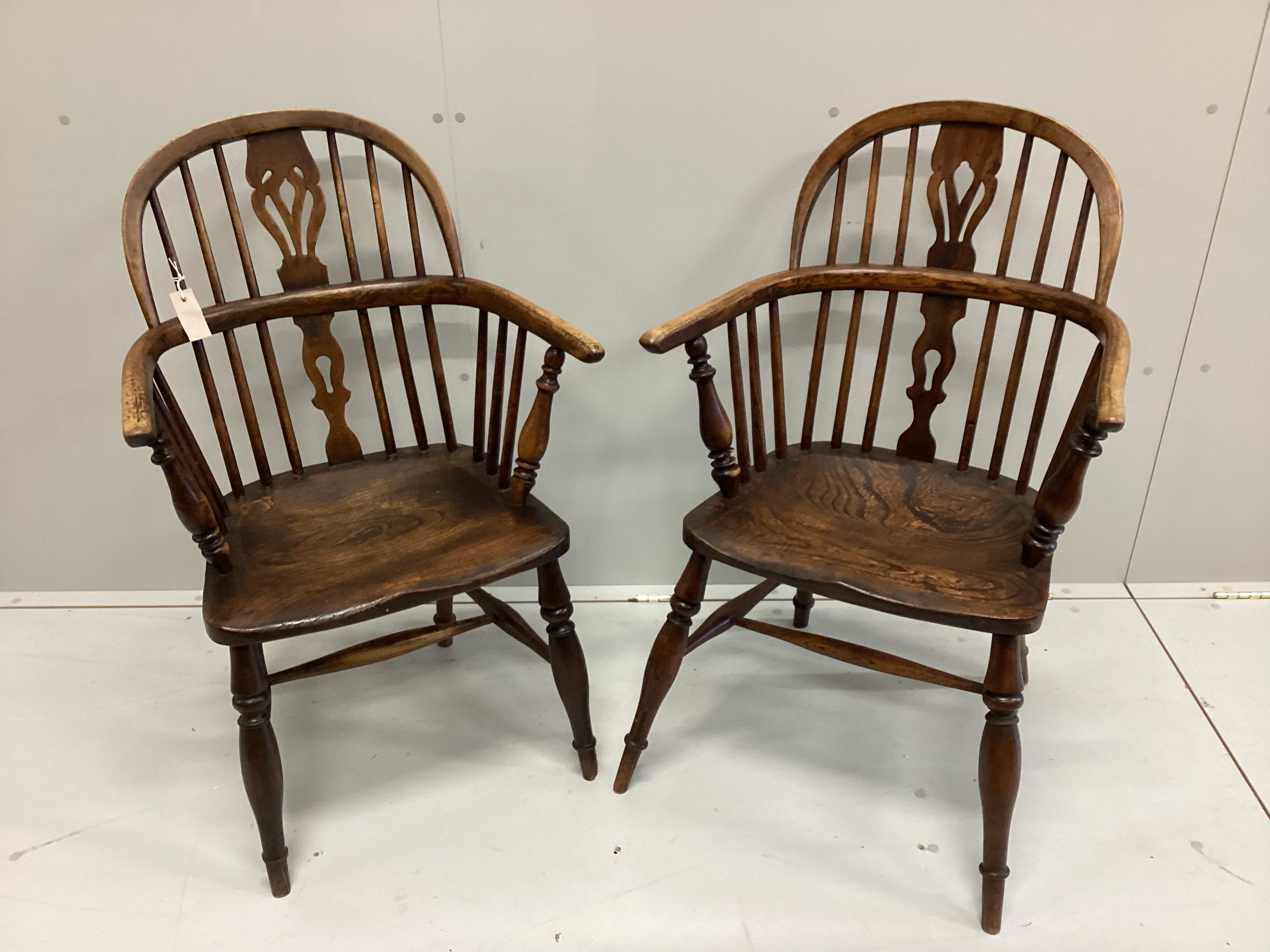 A near pair of 19th century ash and elm Windsor elbow chairs, width 59cm, depth 37cm, height 94cm                                                                                                                           