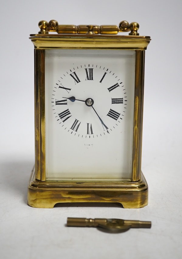 An early 20th century brass repeating carriage clock with key, 13cm. Condition - fair to good, not tested as working                                                                                                        