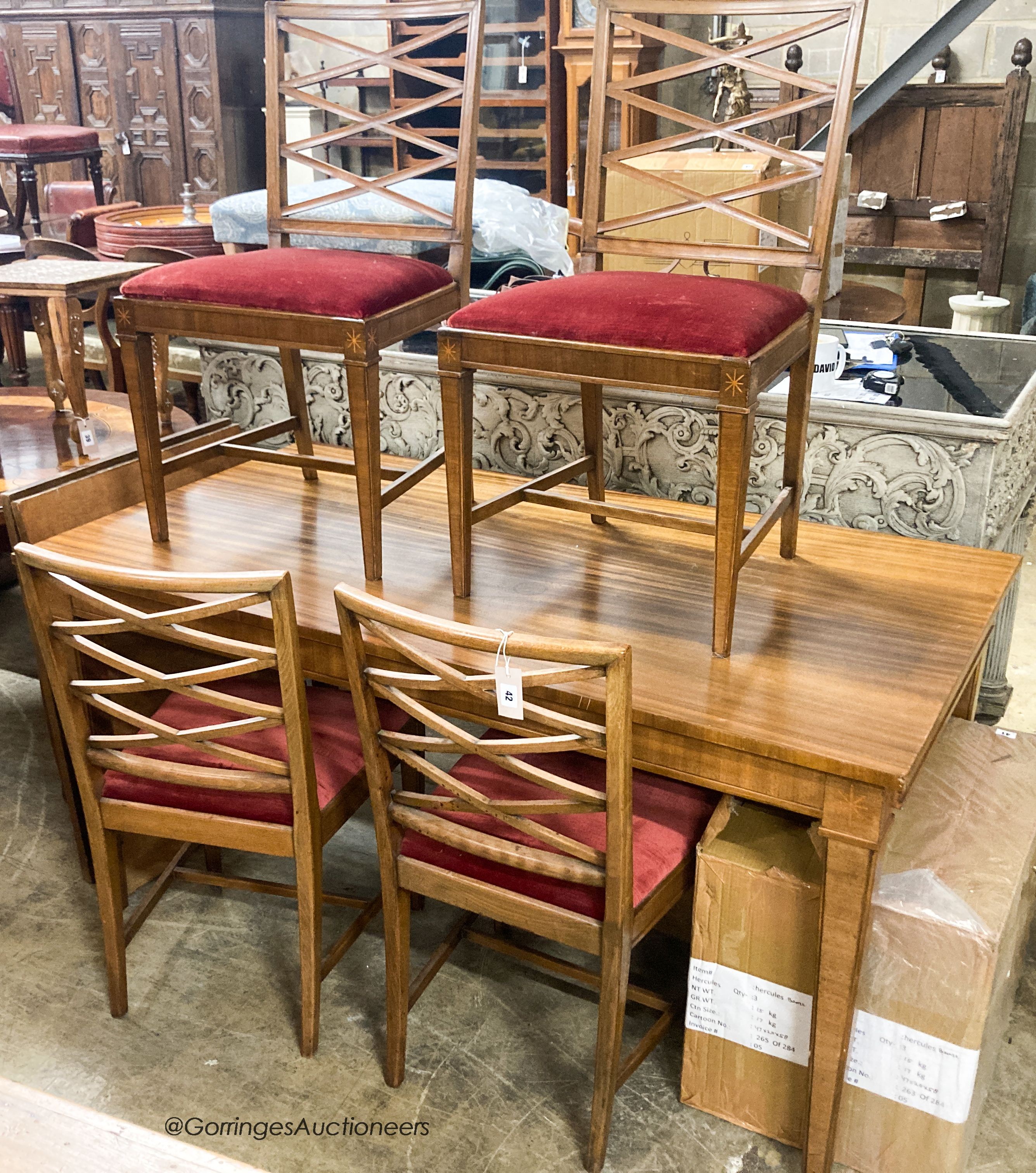 A Swedish walnut and beech dining suite comprising rectangular table. 200cm extended (two spare leaves) and four lattice back chairs with upholstered drop in seats                                                         