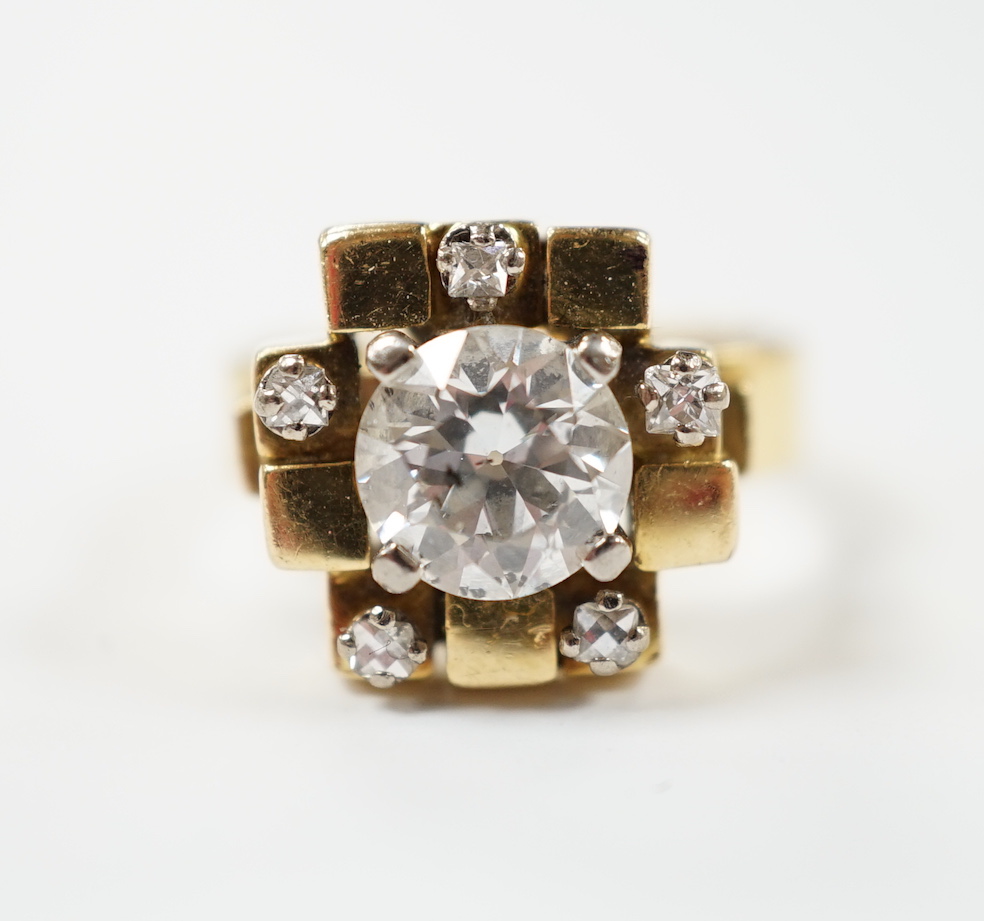 A 1970's 18ct gold and single stone diamond set ring, with five stone diamond mounted setting, size L, gross weight 10.1 grams, the central stone weighing approximately 1.40ct.                                            